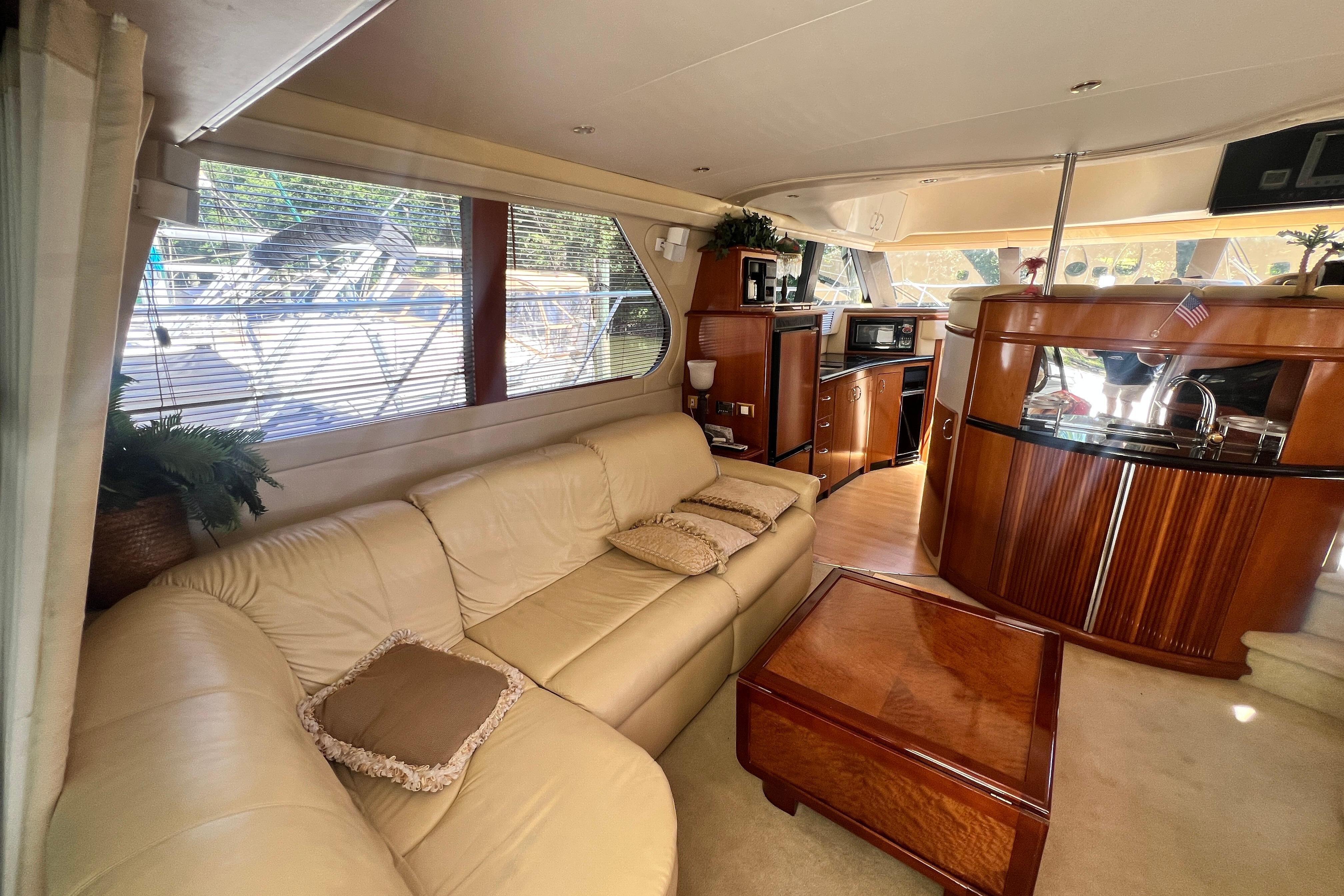 Luxurious interior of a 2003 Carver 450 Voyager Pilothouse yacht with leather seating and wood finishes.