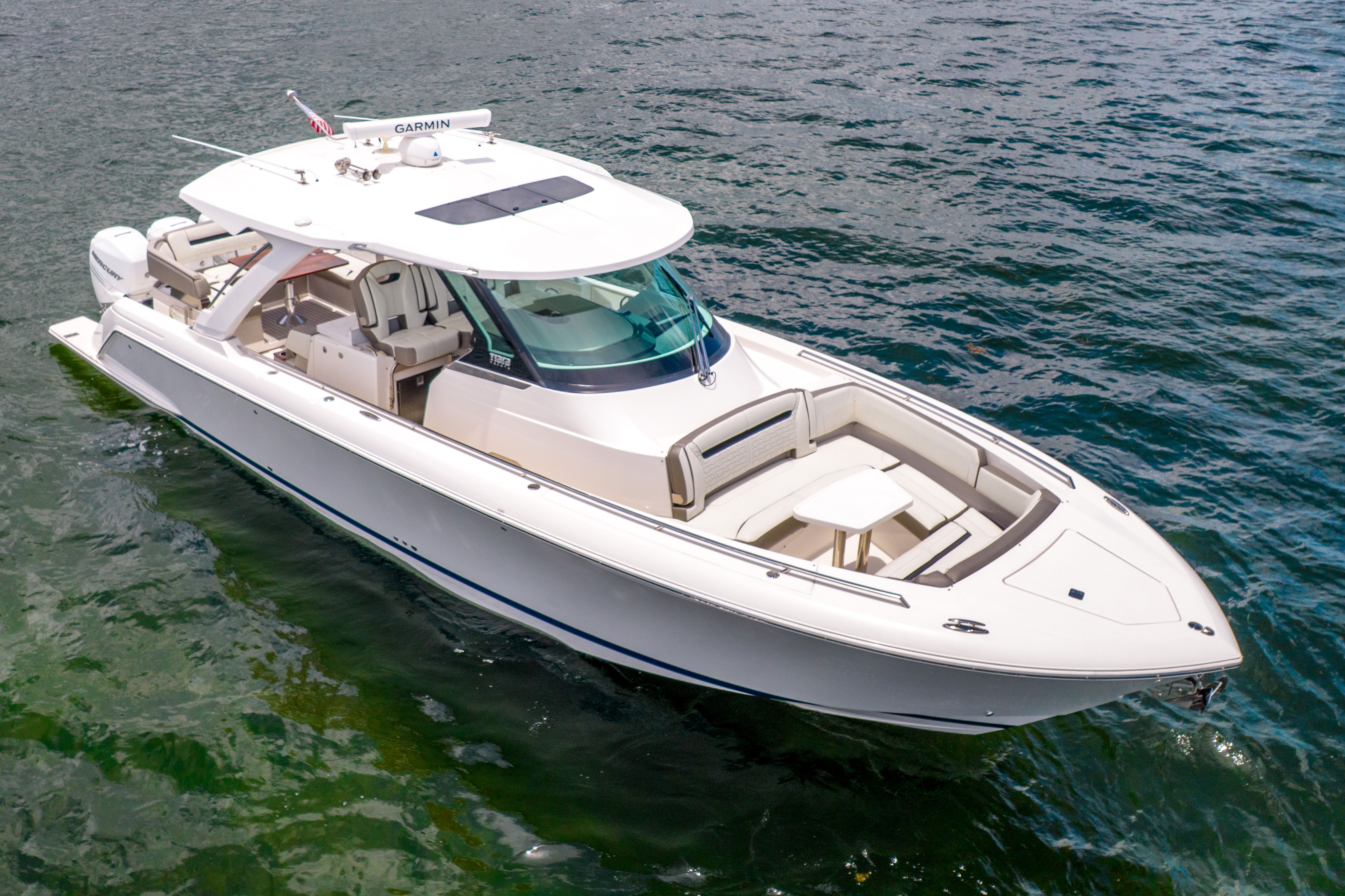 2023 Tiara Yachts 38 LS on calm water, featuring a sleek design and spacious deck.