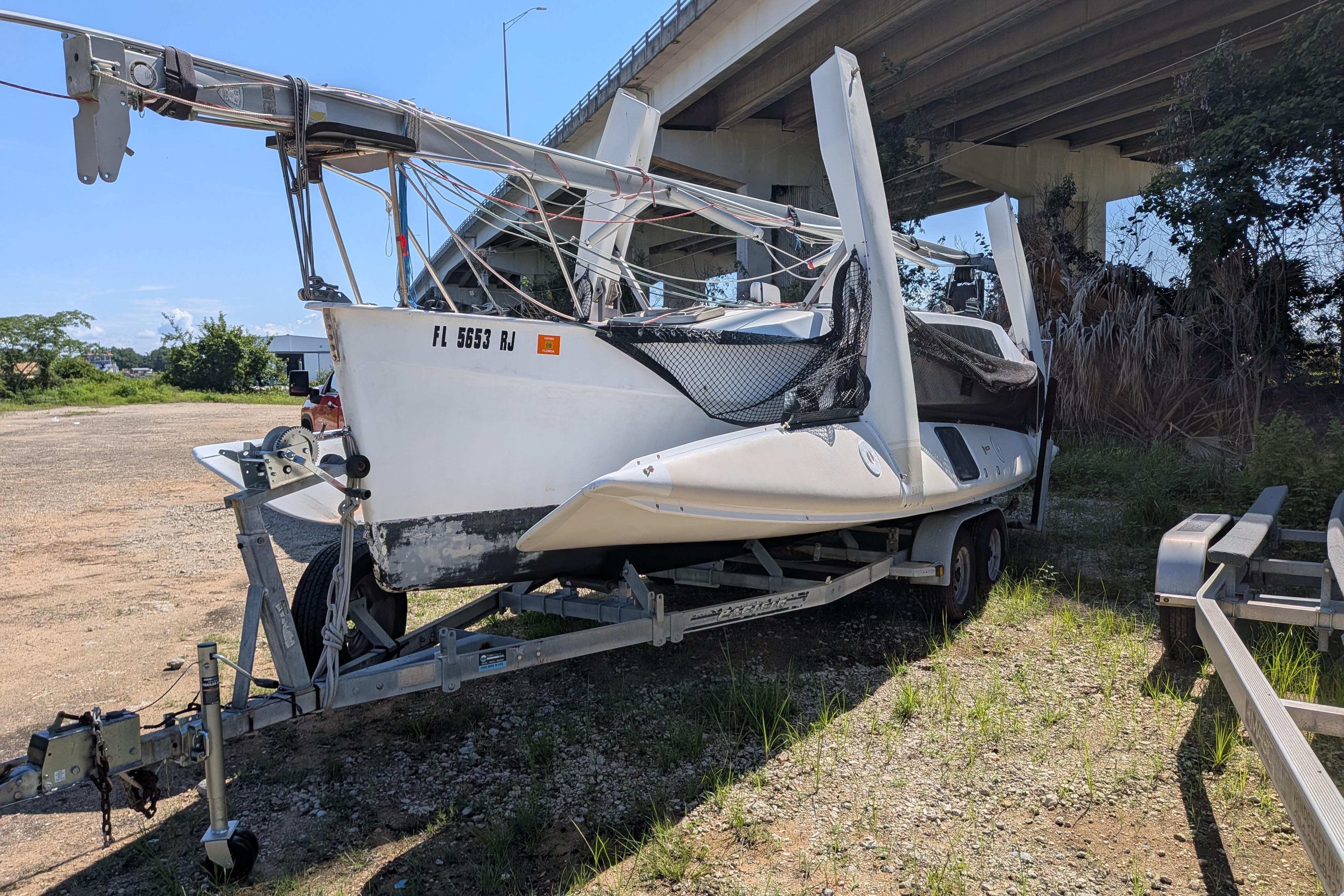 1991 Corsair F-27 sailboat on trailer under bridge, ready for transport.