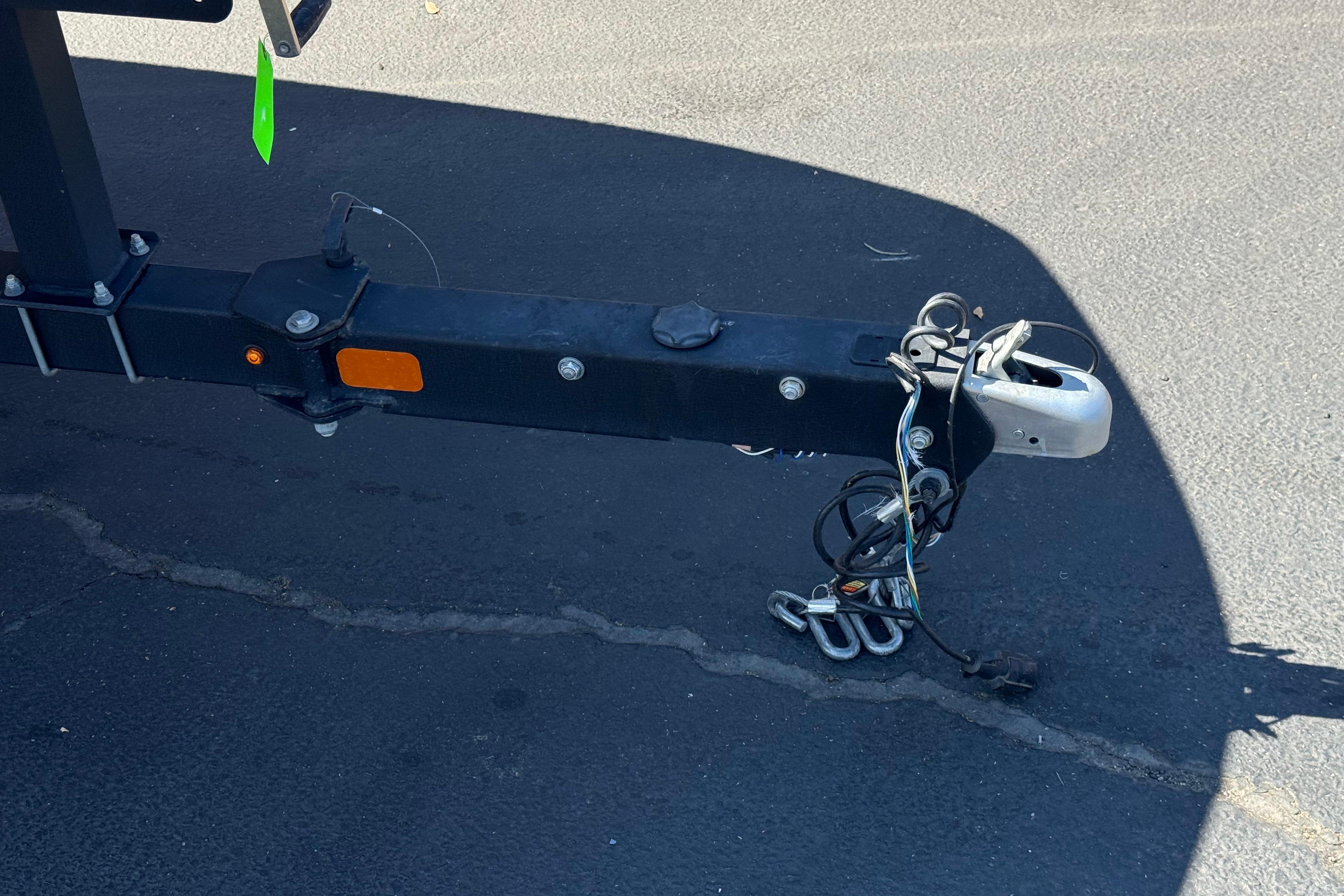 Trailer hitch of a 2019 Tahoe 2150 on asphalt pavement.