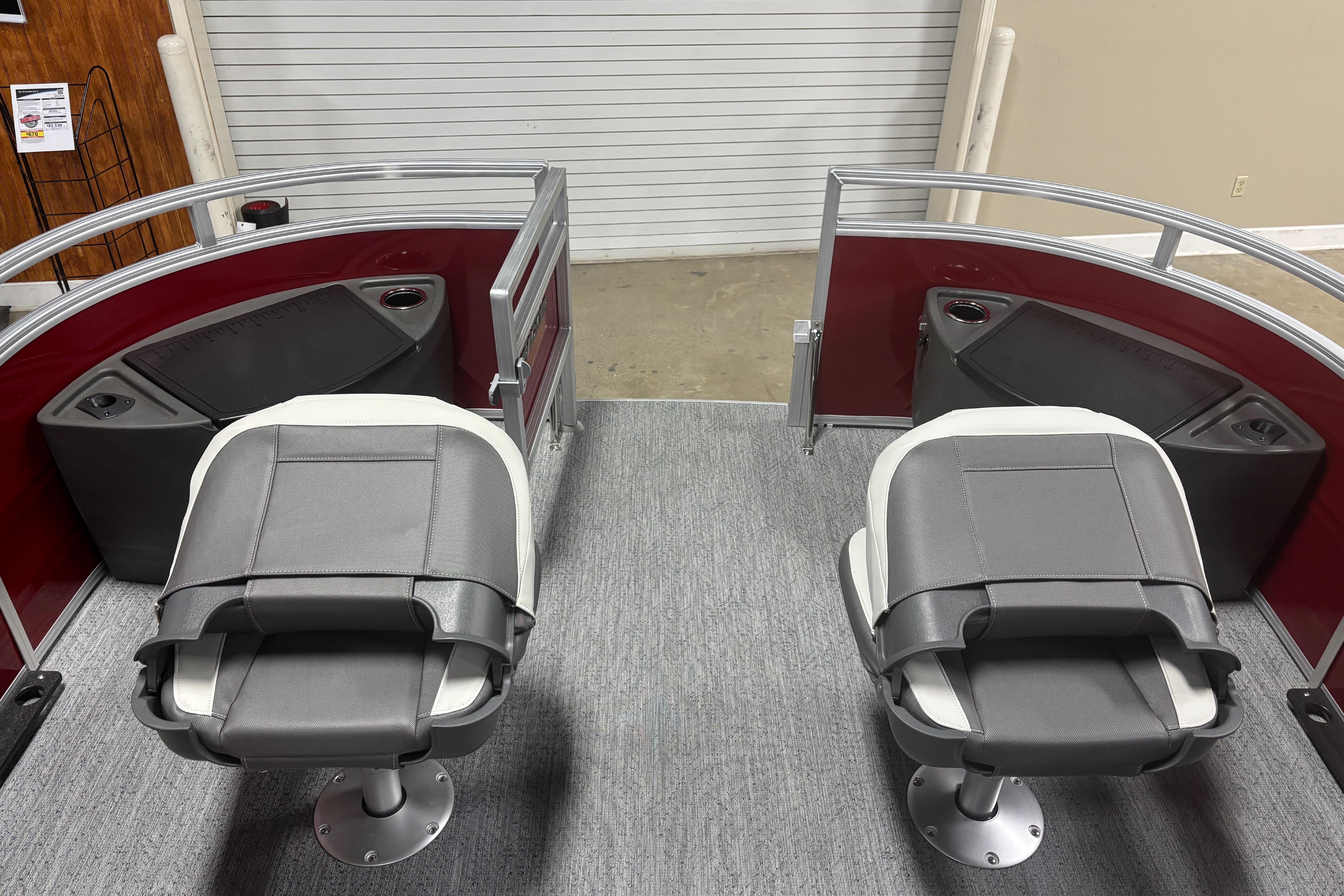 2026 Sun Tracker Fishin' Barge 22 DLX interior with two swivel seats and storage compartments.