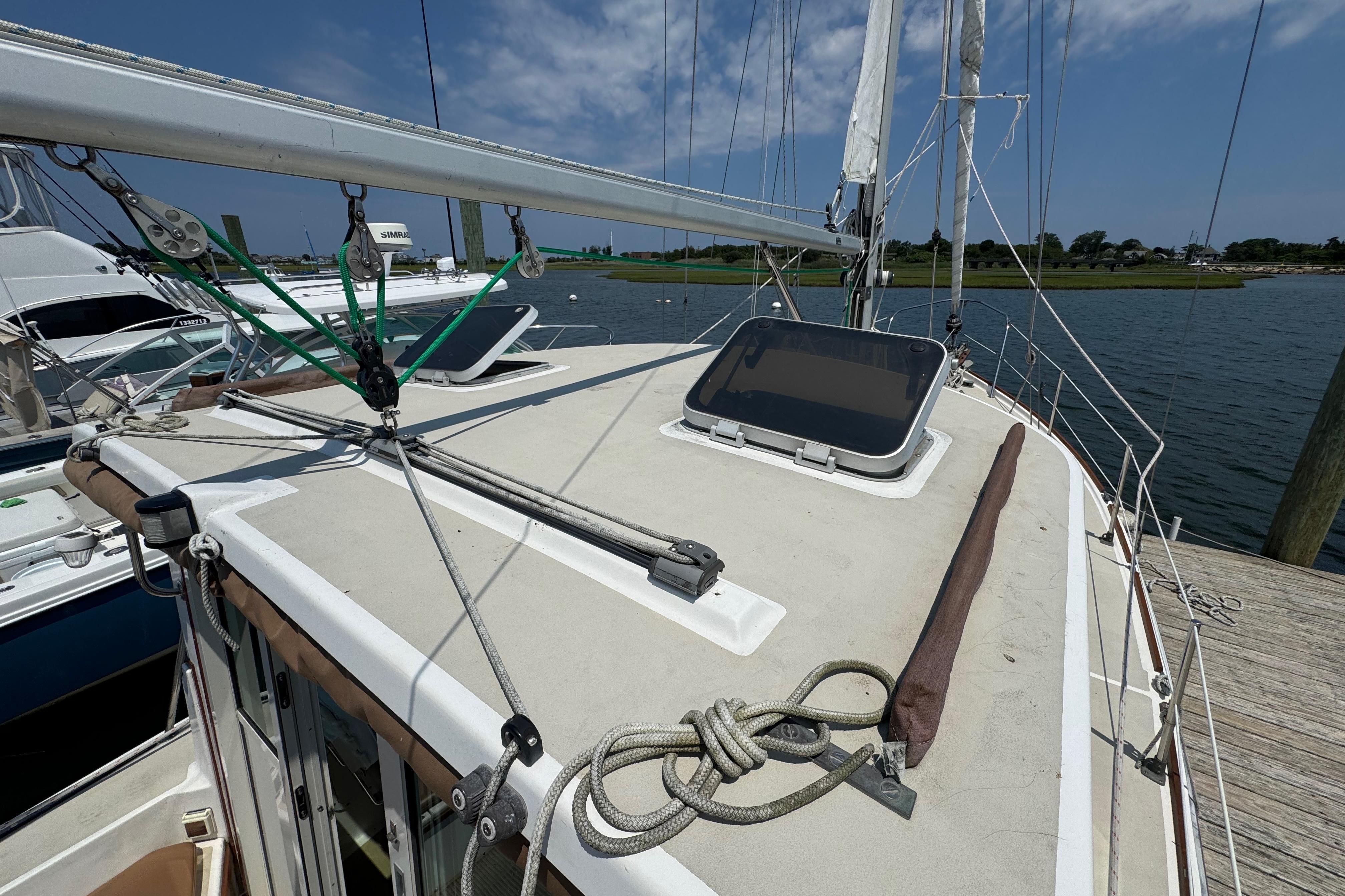 1989 Cape Dory 30 Motorsailer docked, showcasing deck and rigging details.