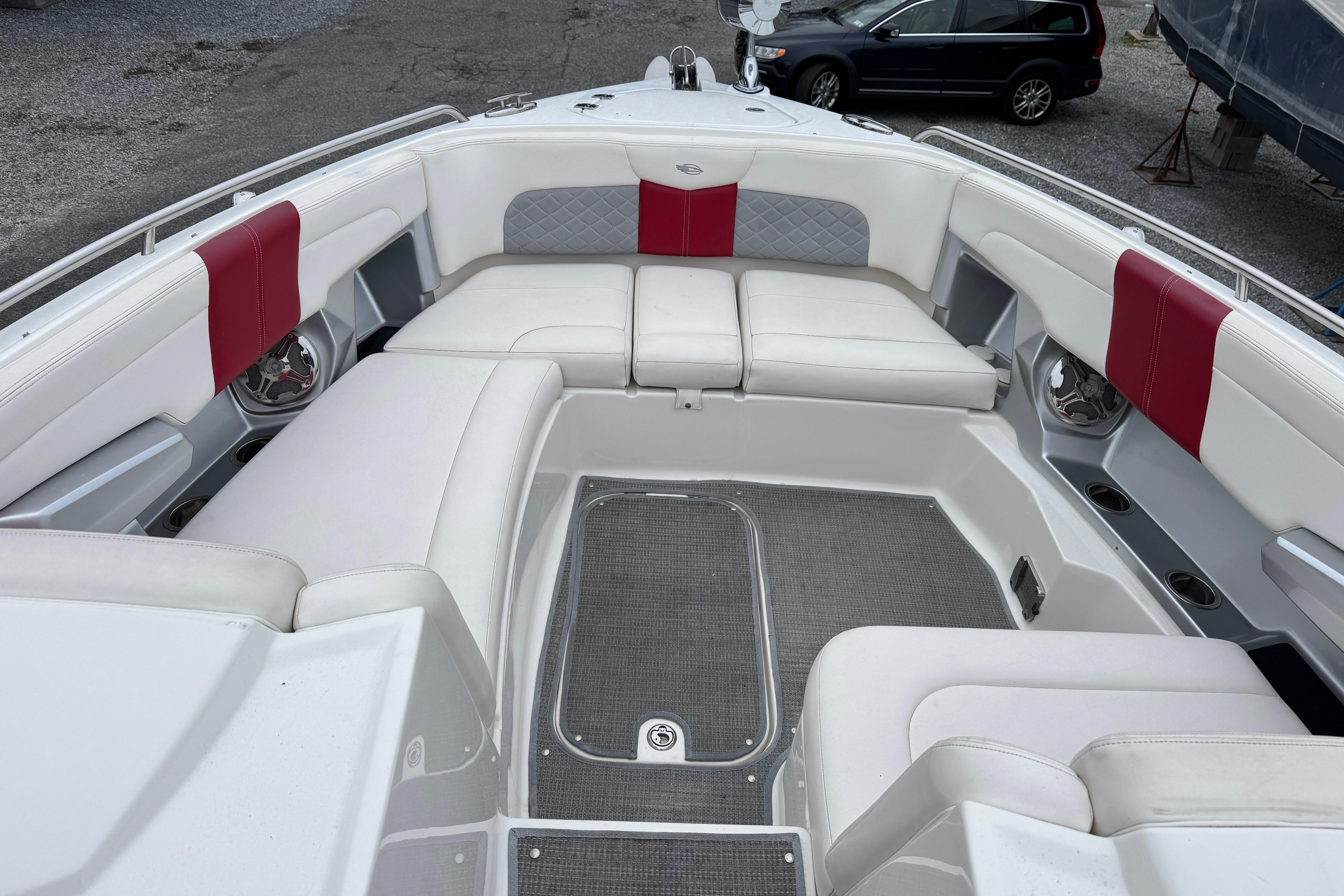 Luxurious seating area on a 2012 Chaparral 327 SSX boat with red accents.