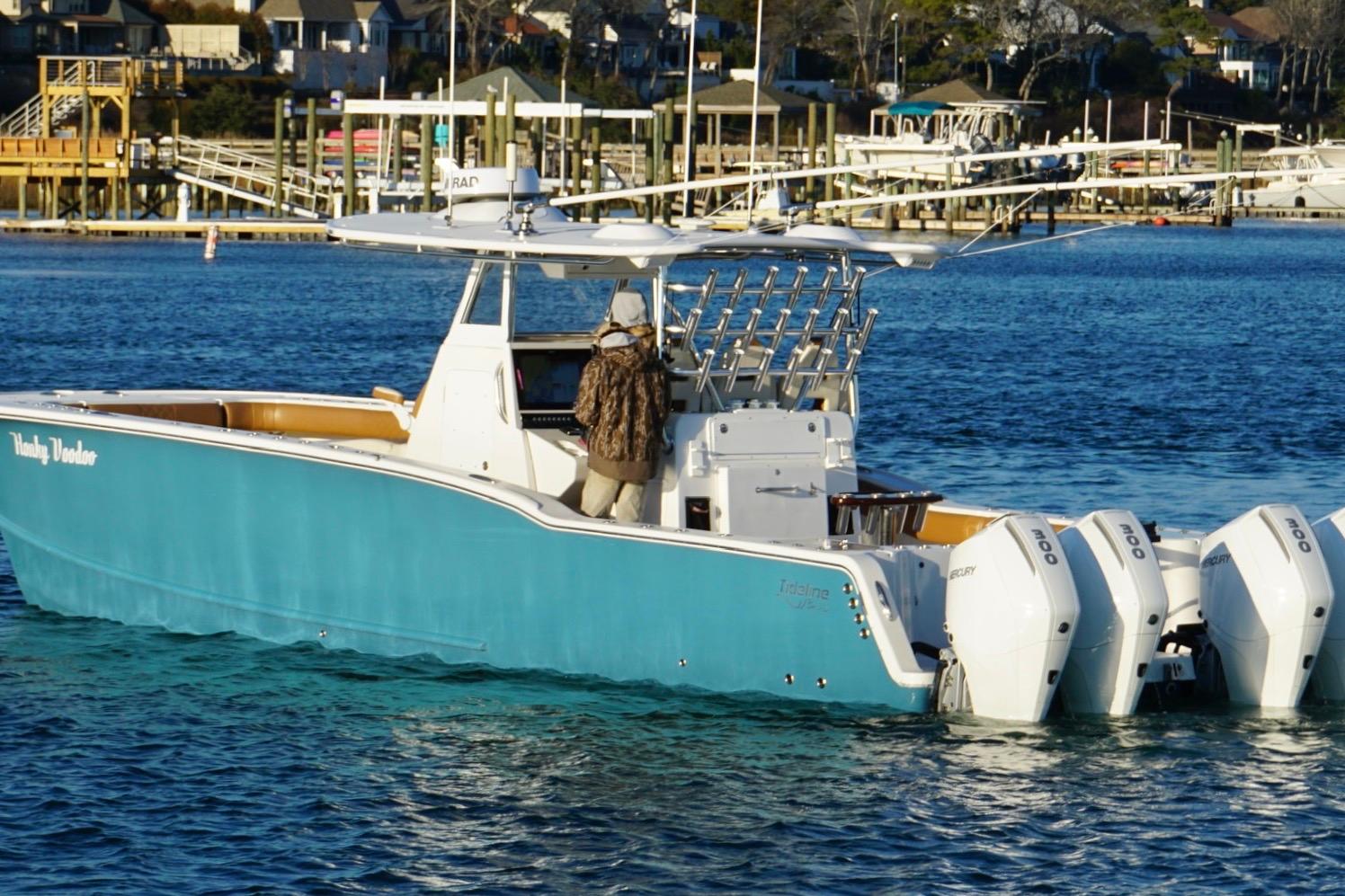2022 Tideline 365 Offshore boat with multiple engines on a calm waterway.