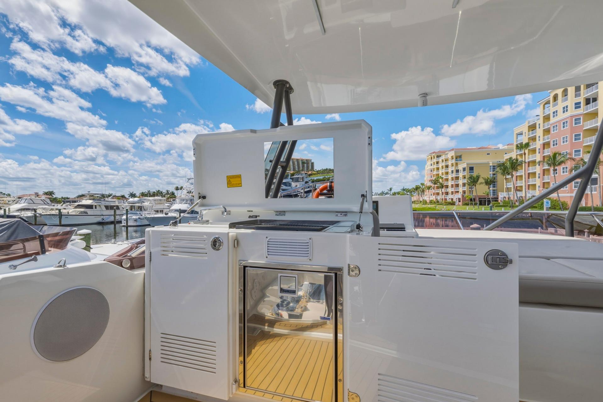 Luxury yacht Prestige 520, 2022 model, docked with modern amenities and scenic marina view.