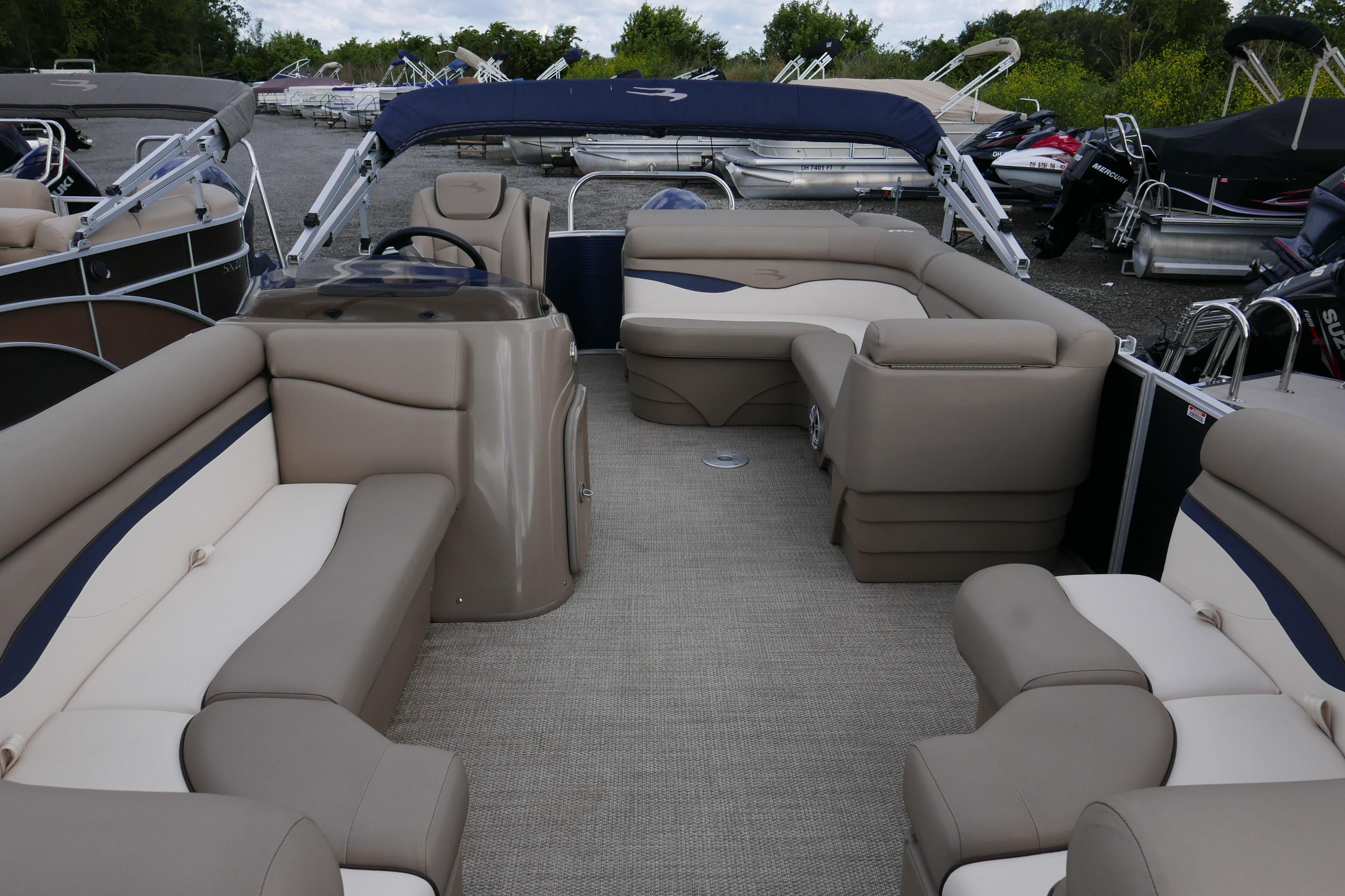 2019 Bennington SX 20 SLXP pontoon boat interior with beige seating and helm.