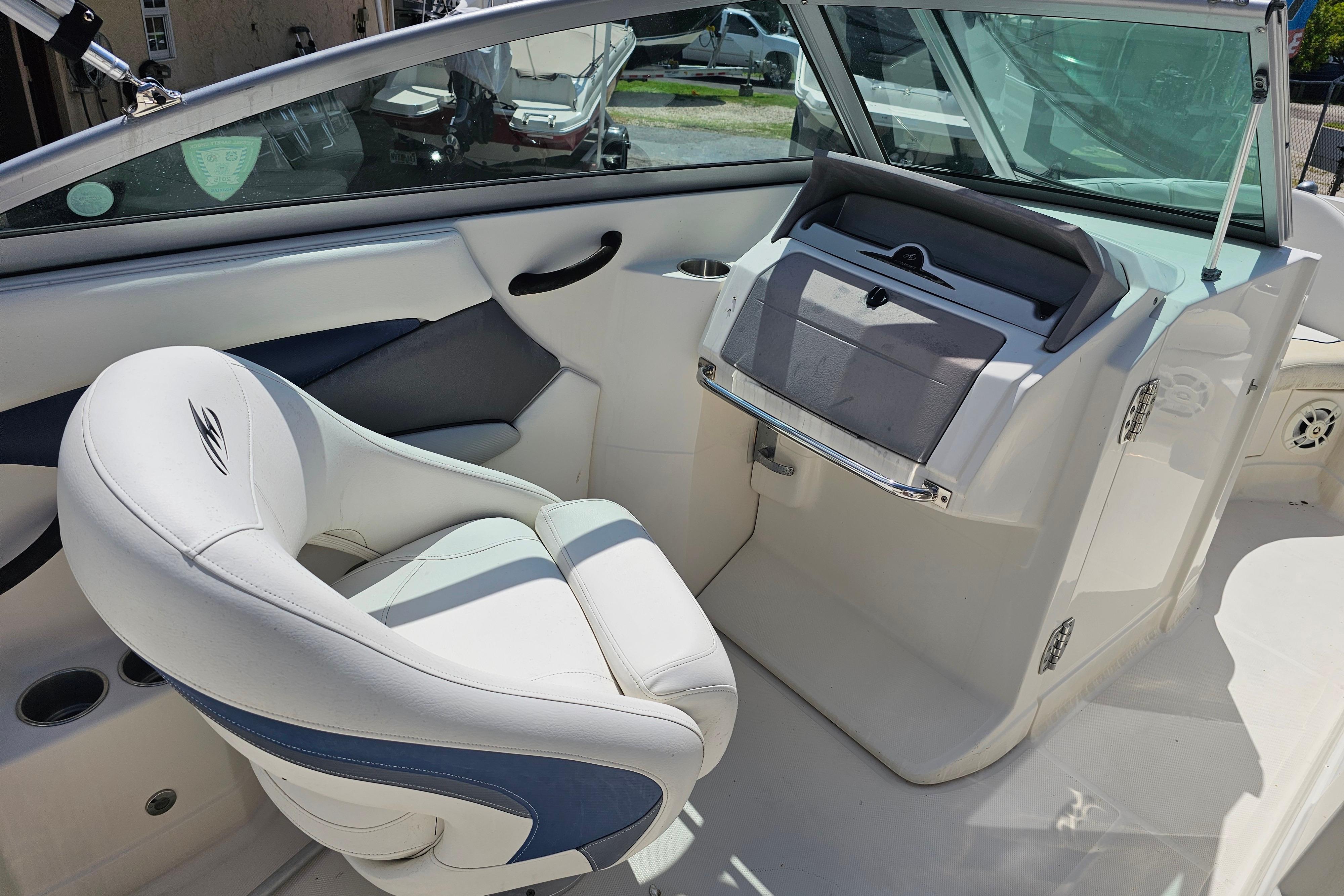 Interior of a 2008 Monterey 220 Explorer boat with white seating and dashboard.