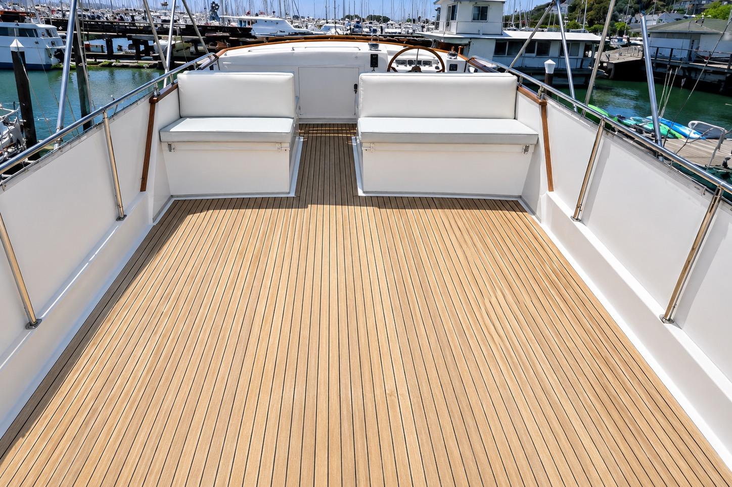 Flybridge of 1989 Grand Banks 42 Classic yacht with teak decking and seating.
