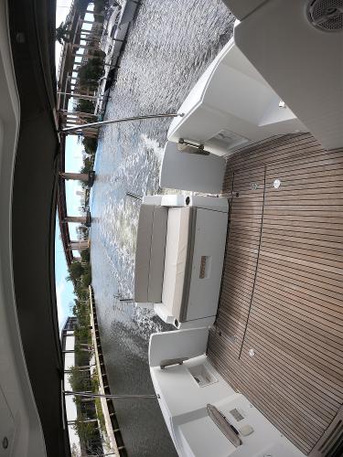 2017 Jeanneau NC 11 boat with spacious deck and waterfront view.