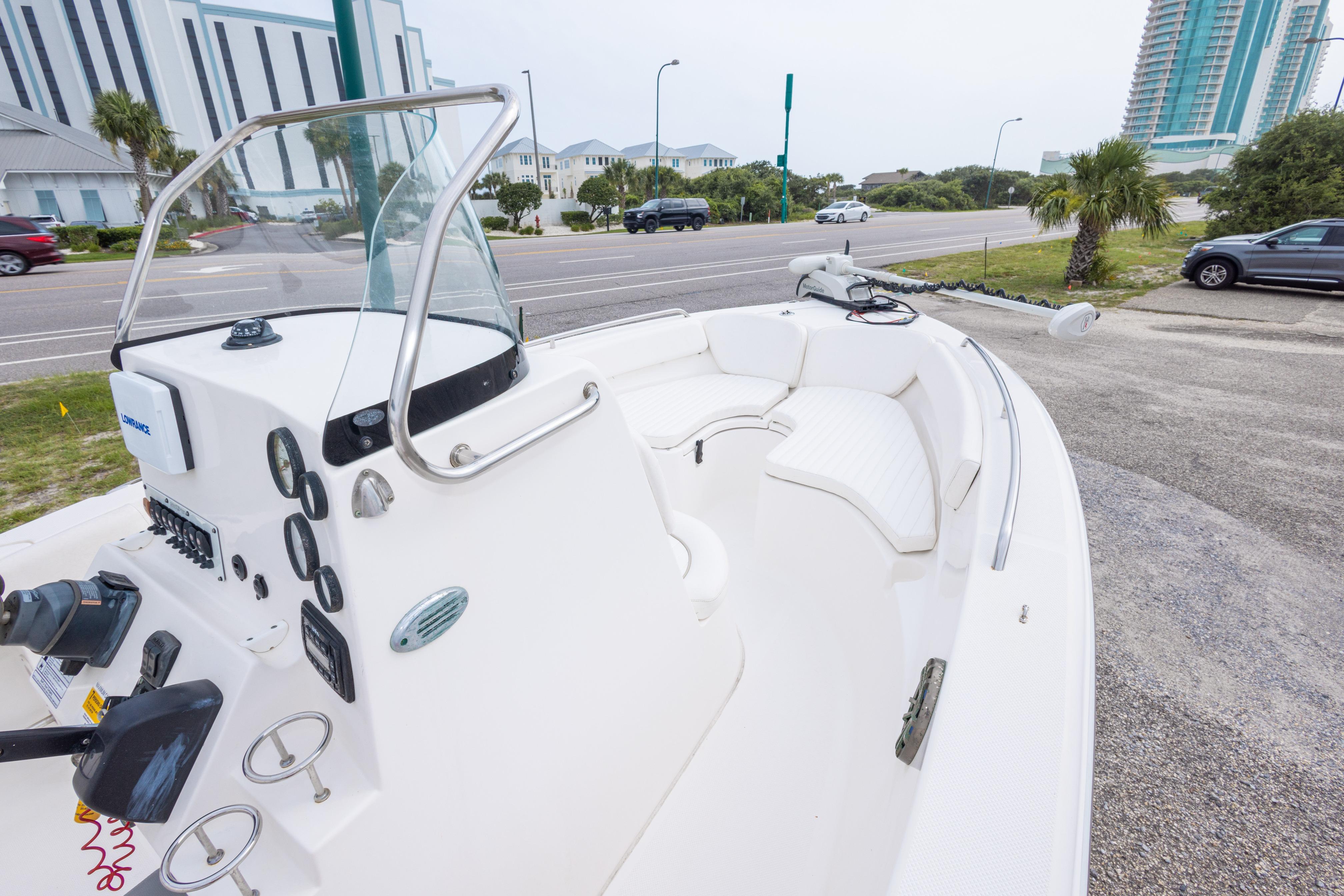 2014 Sea Fox 209 Commander boat with white interior, parked near a road.