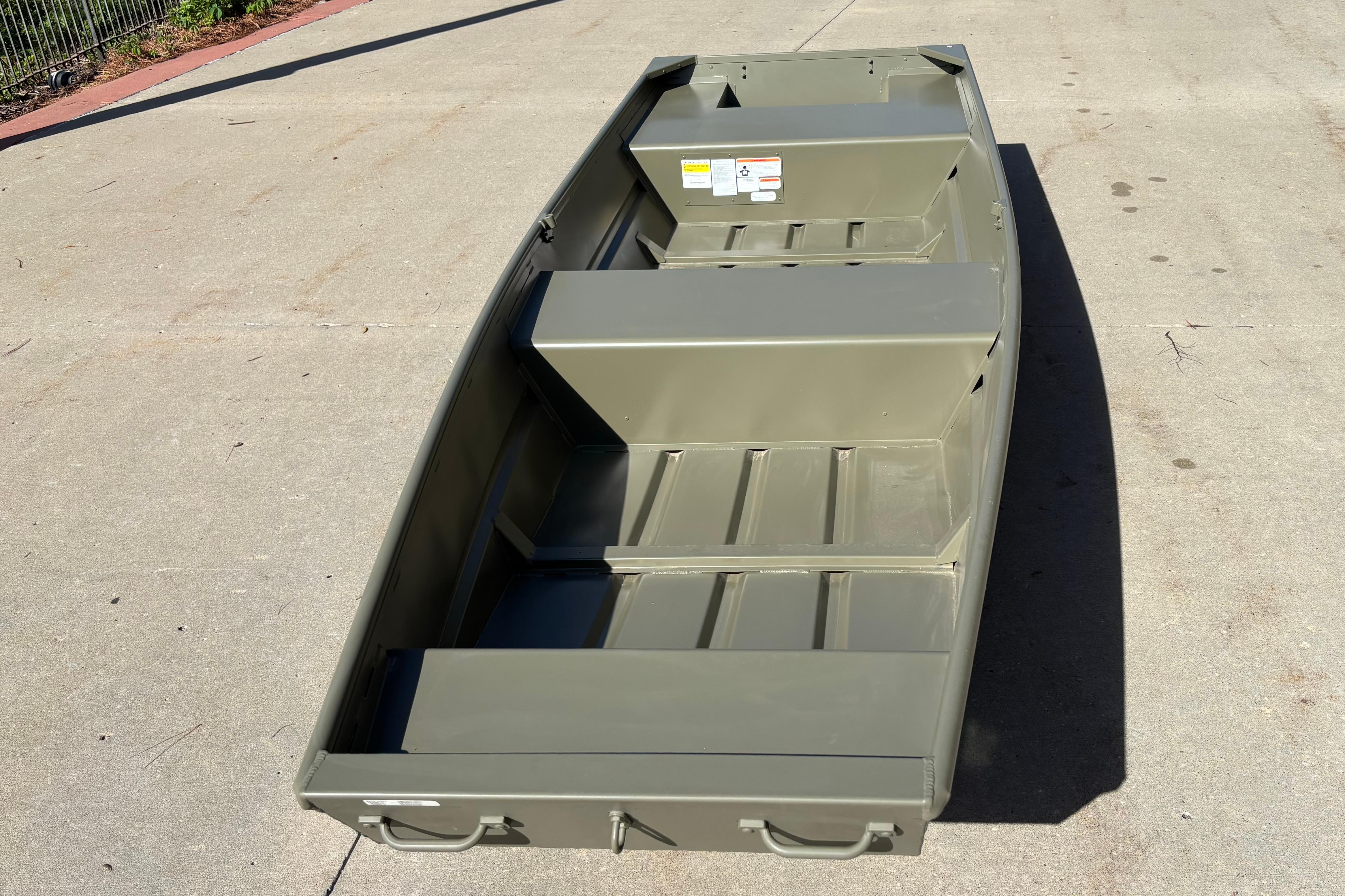 2026 Tracker Grizzly 14 Jon boat on concrete surface, showcasing interior layout and design.