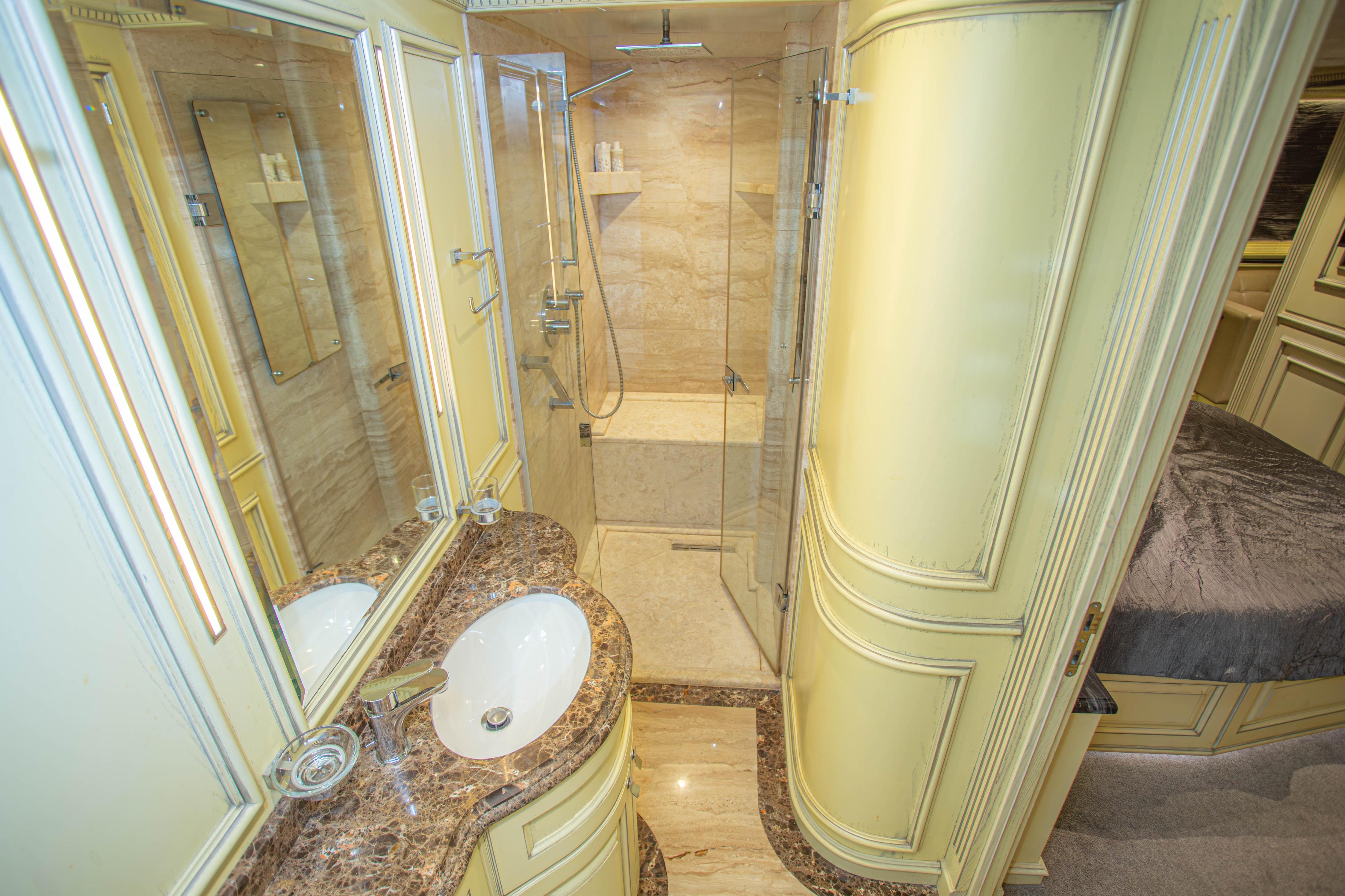 Luxurious bathroom in 2014 Fifth Ocean Yachts 24m Explorer Yacht with marble accents and modern fixtures.