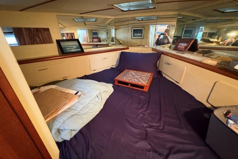 Interior of 1987 Tollycraft 34 Sundeck Motor Yacht with cozy bedding and decor.