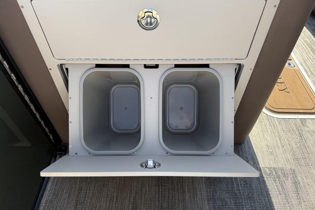 Storage compartment with dual bins on a 2026 Godfrey Monaco 235 SB boat.