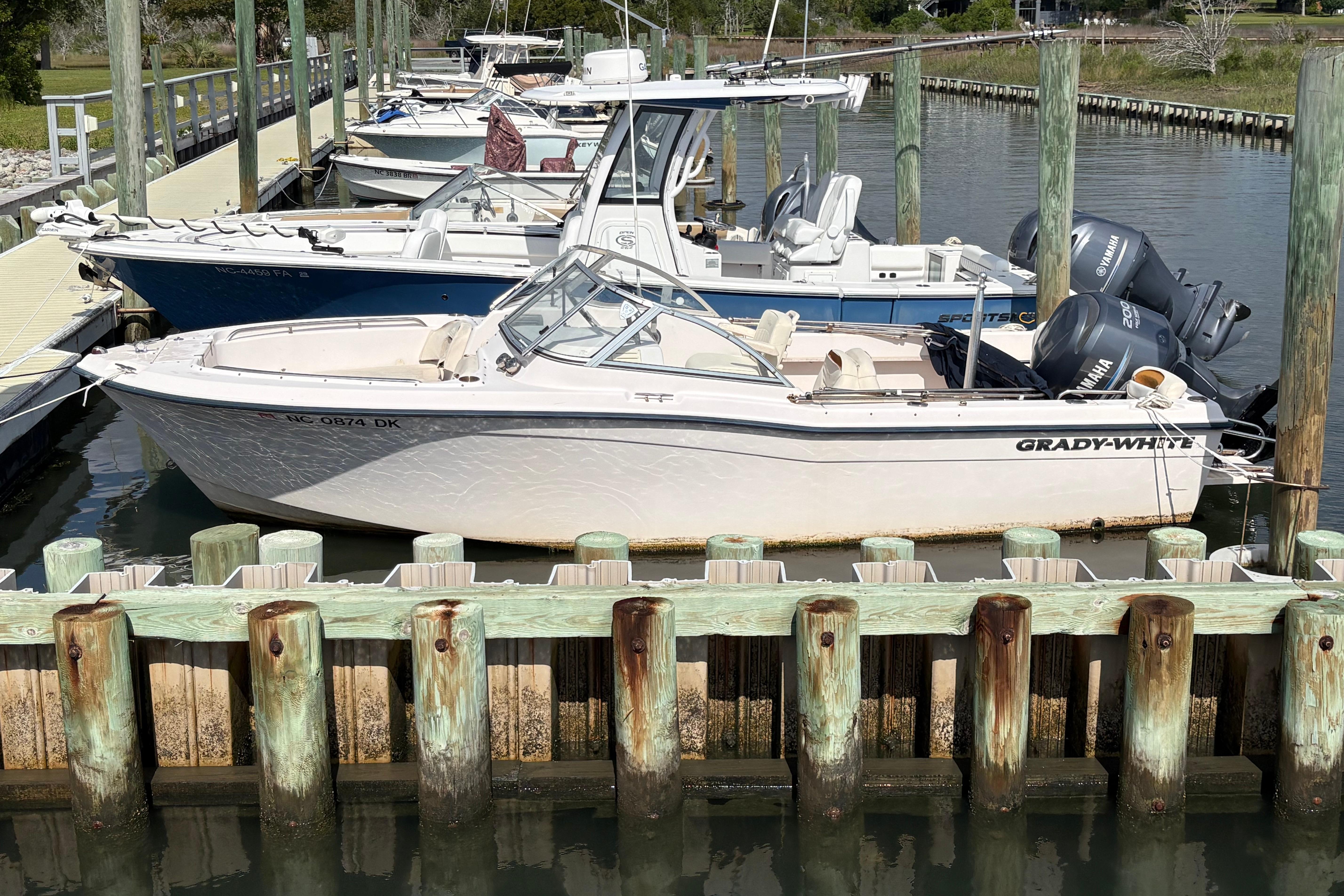 2008 Grady-White Tournament 205 boat docked at a marina with other vessels.