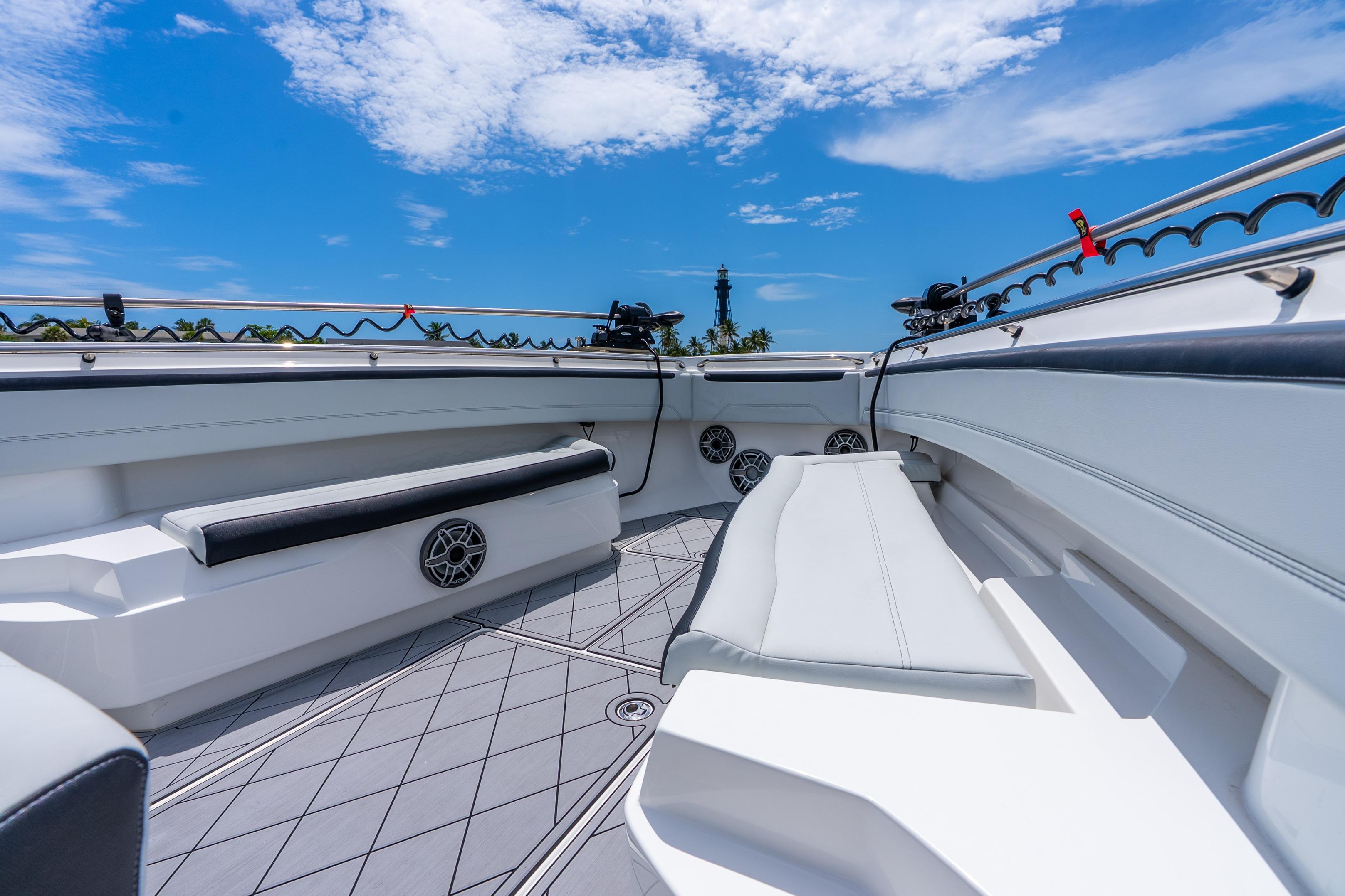 2024 Nor-Tech 452 Super Fish boat interior with sleek seating and modern design under blue sky.