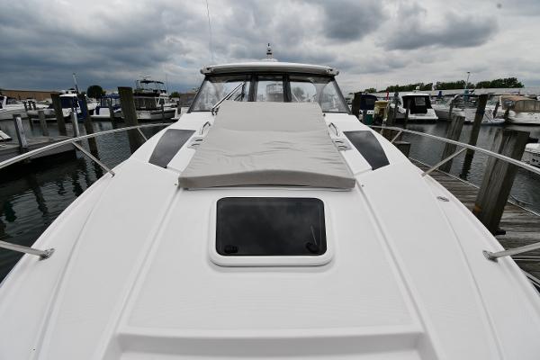 2021 Regal 35 Sport Coupe docked, showcasing sleek design and spacious deck under cloudy skies.