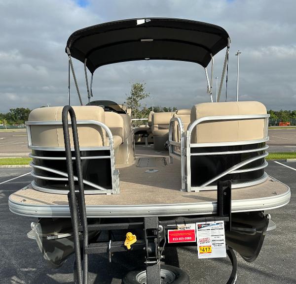 2023 Sun Tracker SportFish 22 XP3 pontoon boat with beige seating and black canopy.