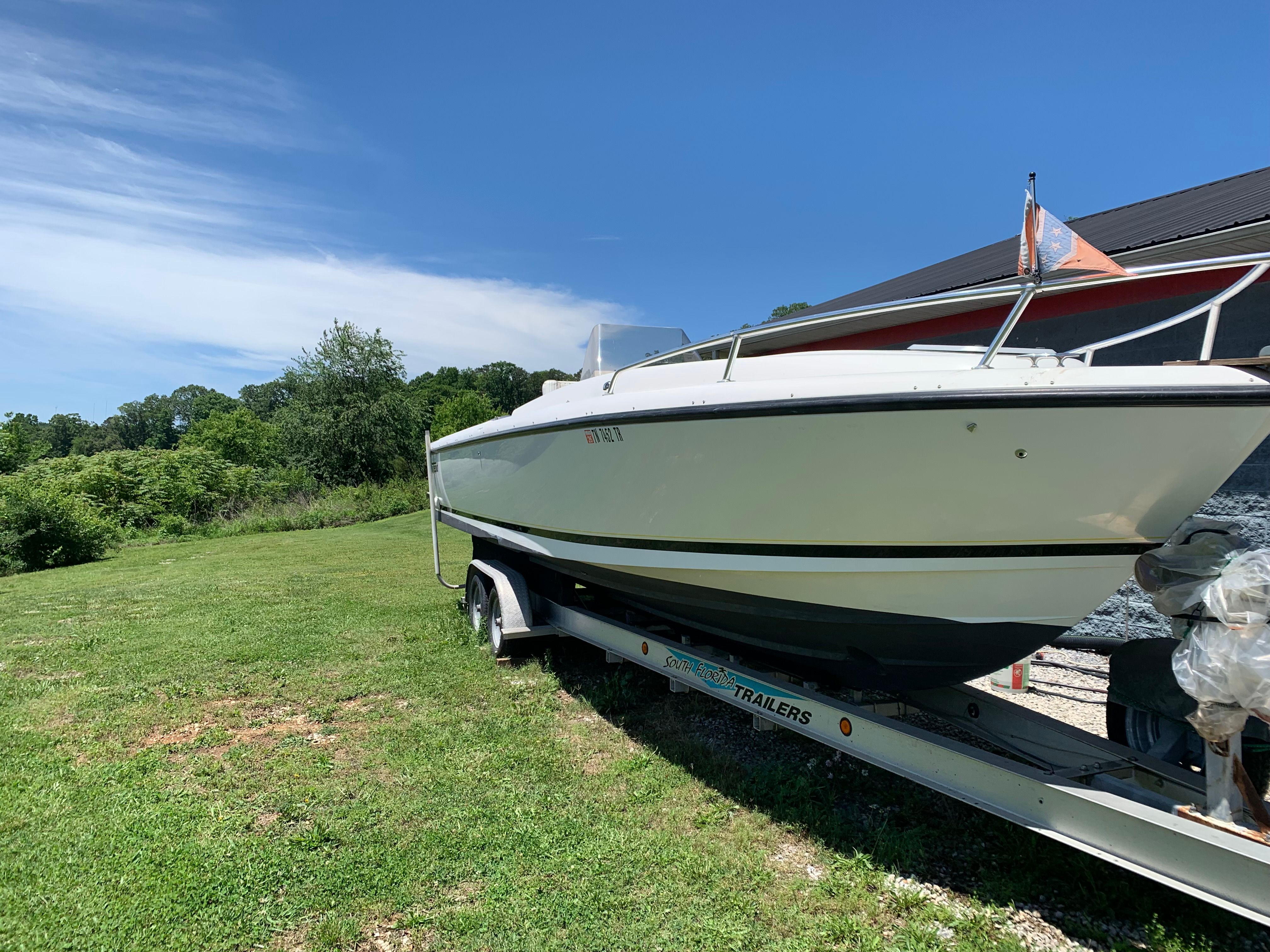 Intrepid 322 Cuddy Center Console boat on trailer, 2002 model.