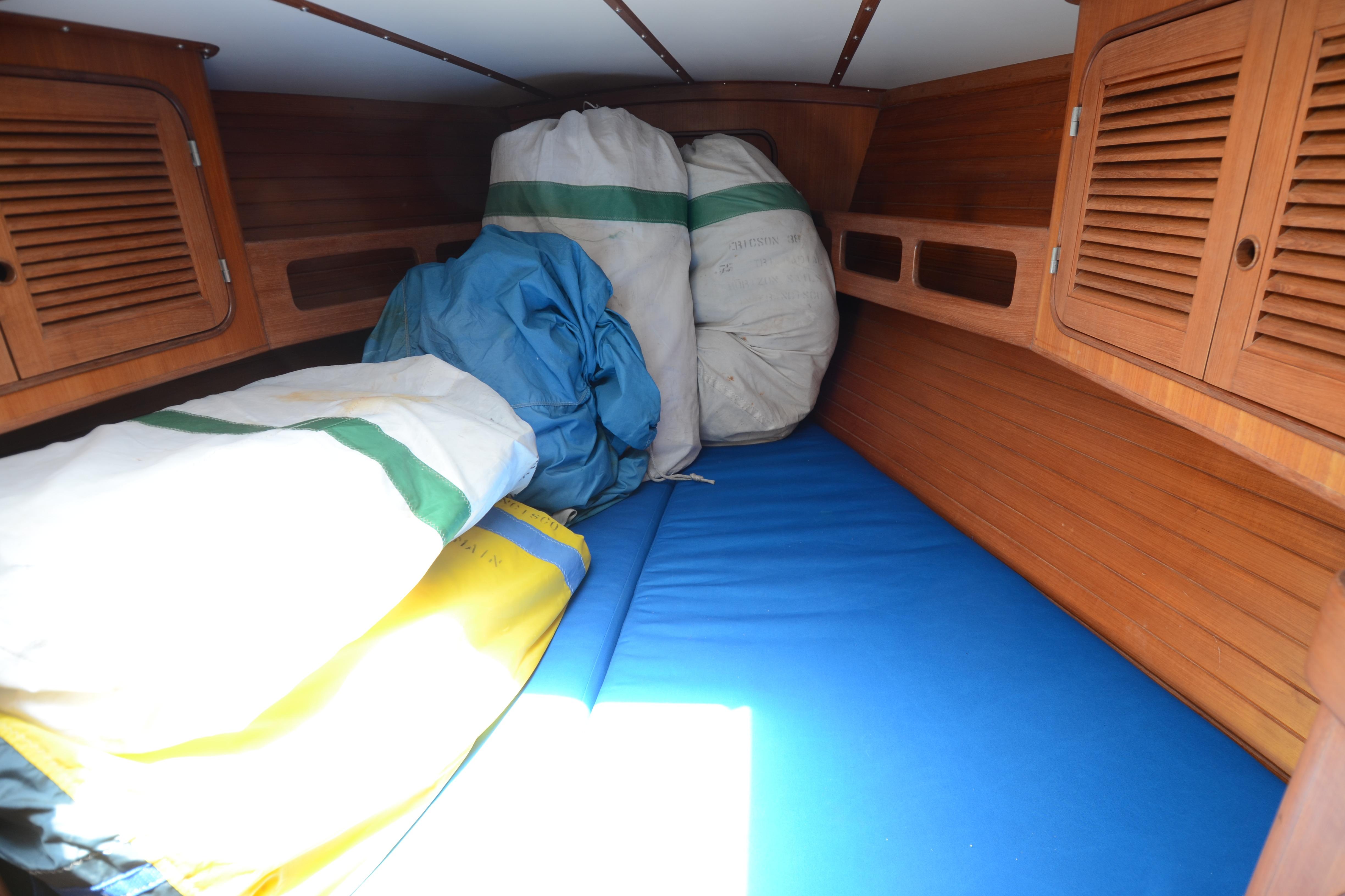 Cozy cabin interior of 1987 Norseman 400 sailboat with storage bags and wooden paneling.