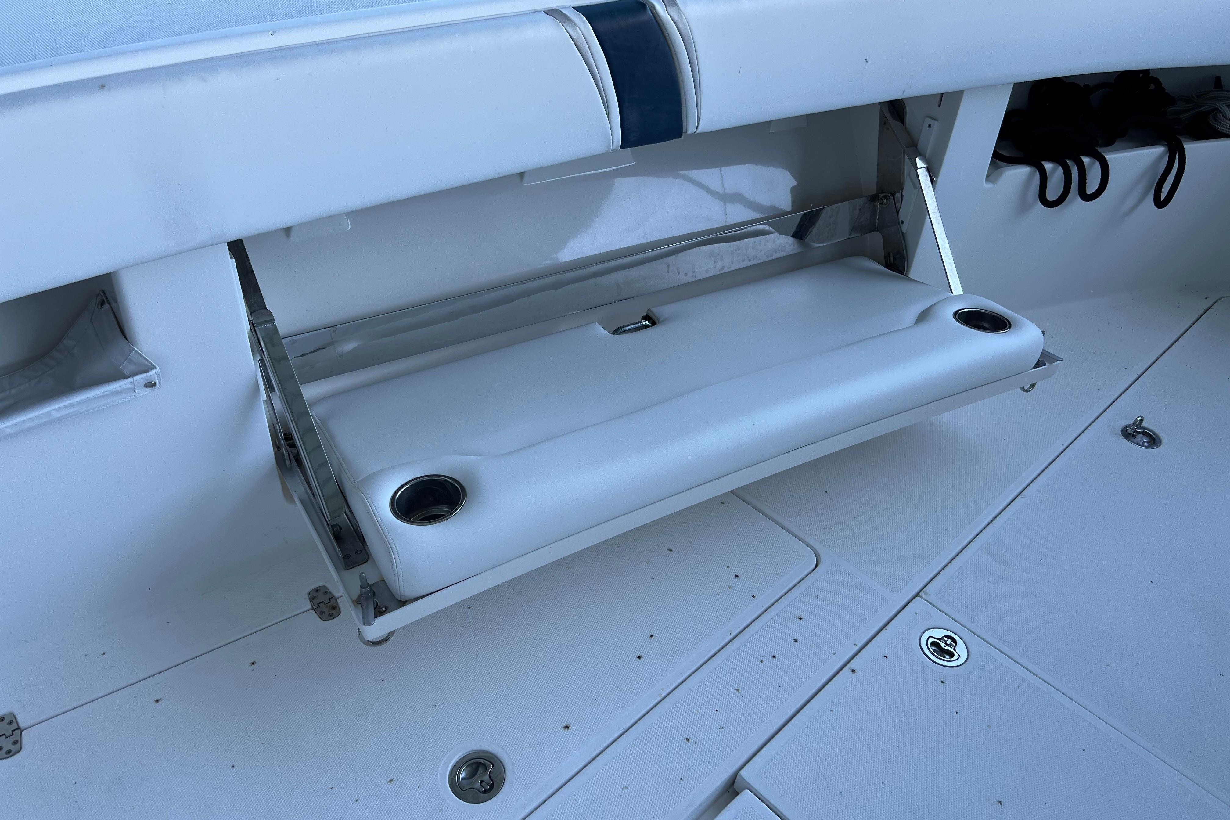 Foldable seat with cup holders on a 2008 SeaVee 39 boat deck.