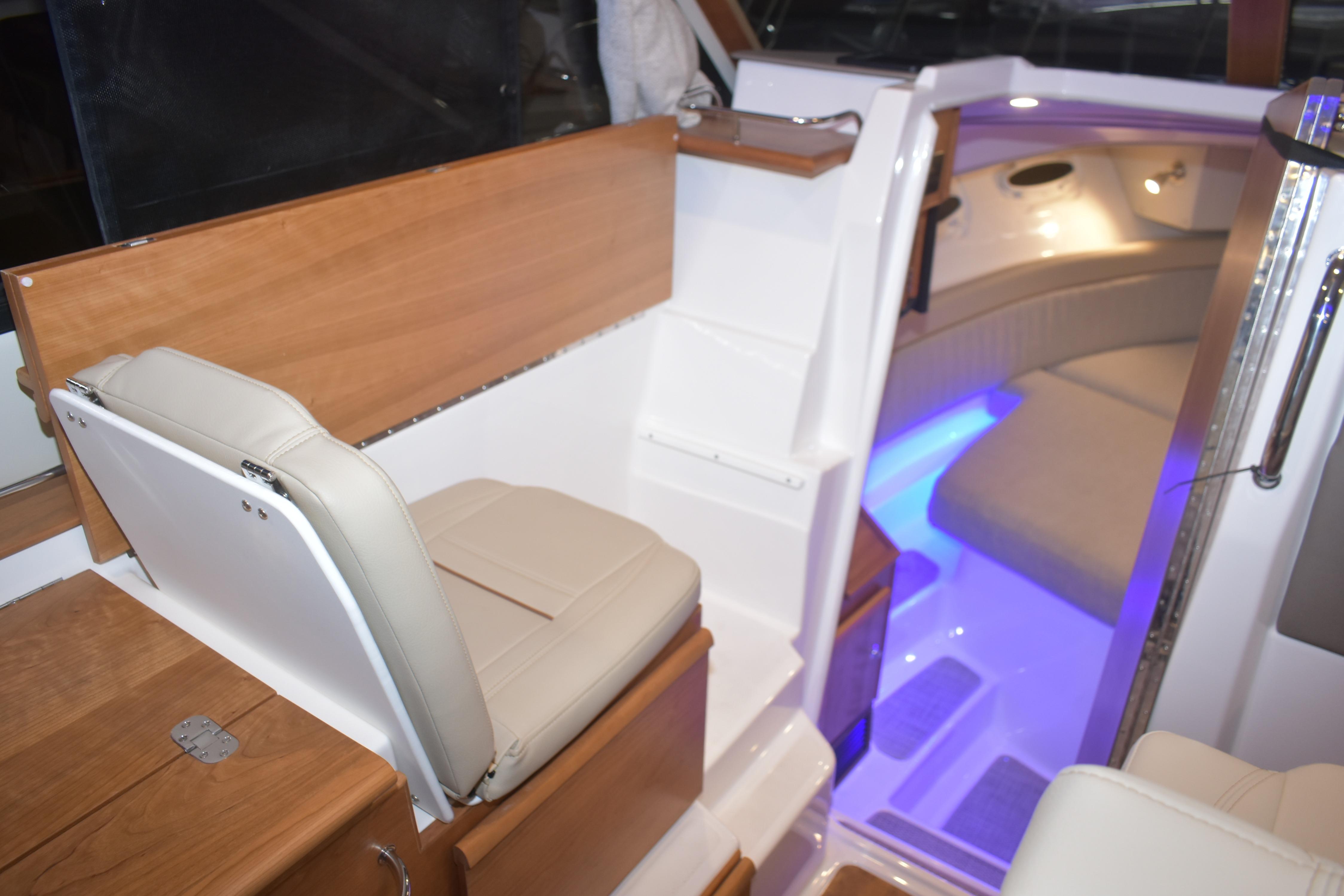 Interior of 2026 Cutwater C-32 CB boat with seating and ambient lighting.