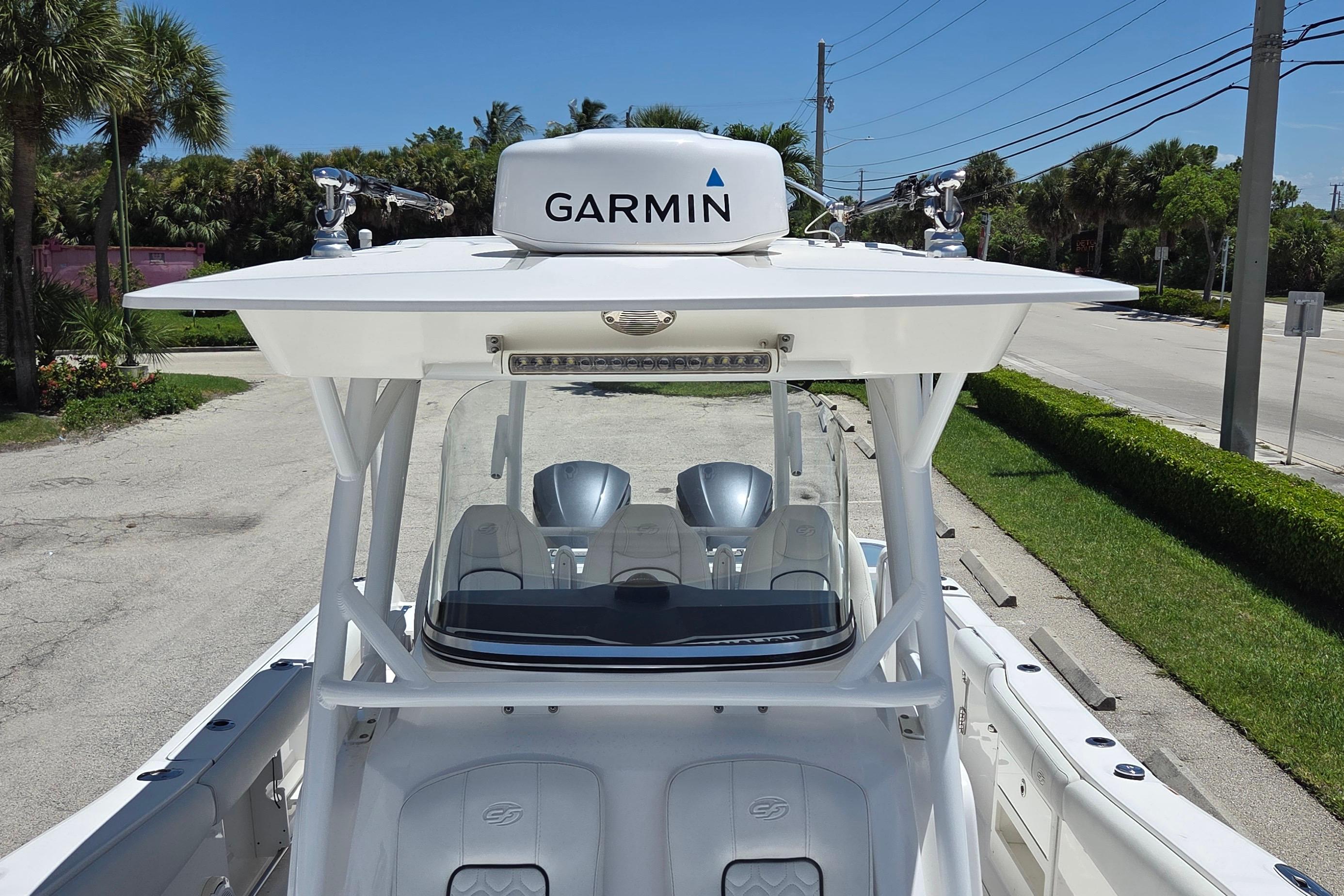2021 Sea Fox 328 Commander boat with Garmin equipment, parked on a sunny street.