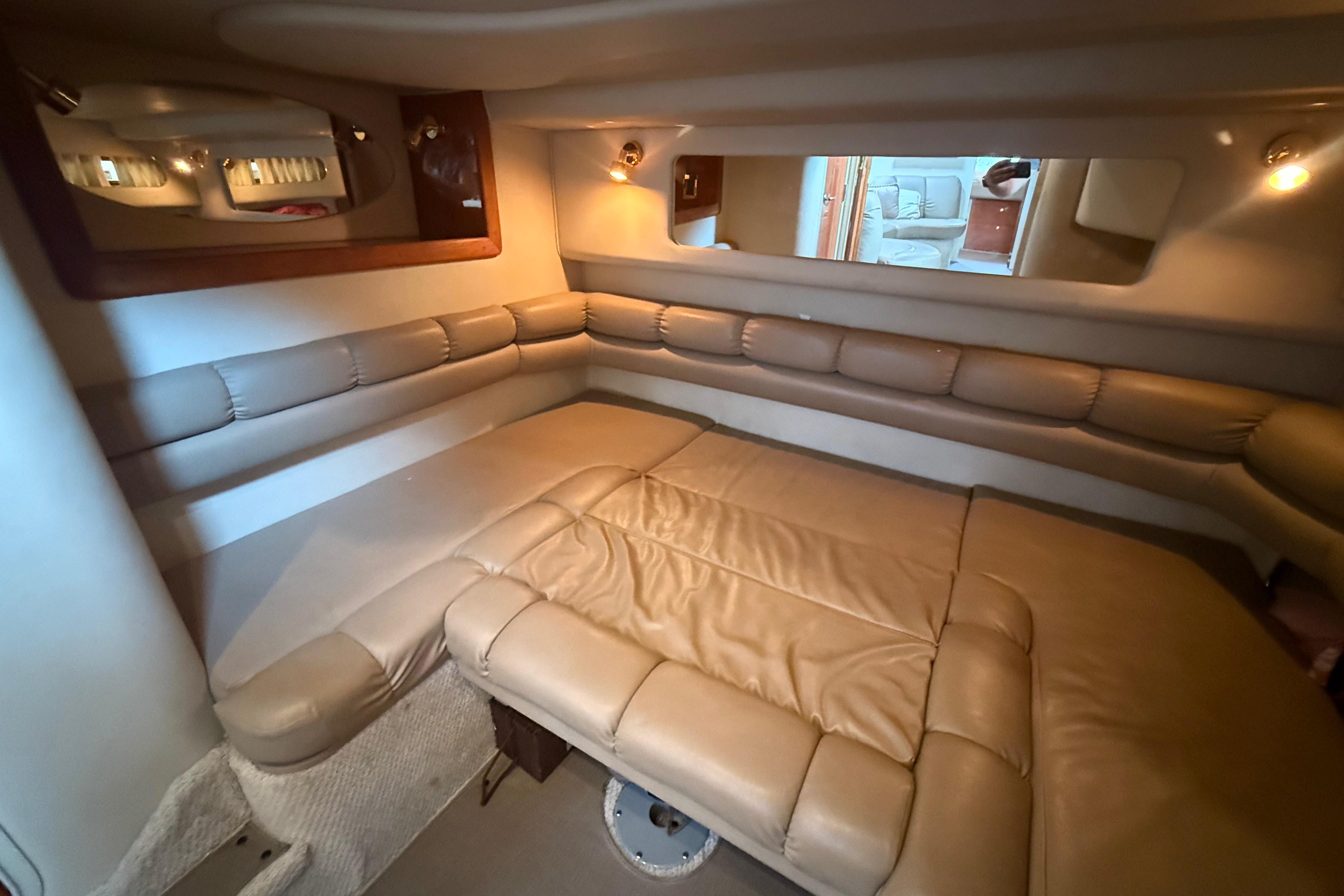 Interior of 1998 Sea Ray Sundancer 400 yacht with beige leather seating and ambient lighting.