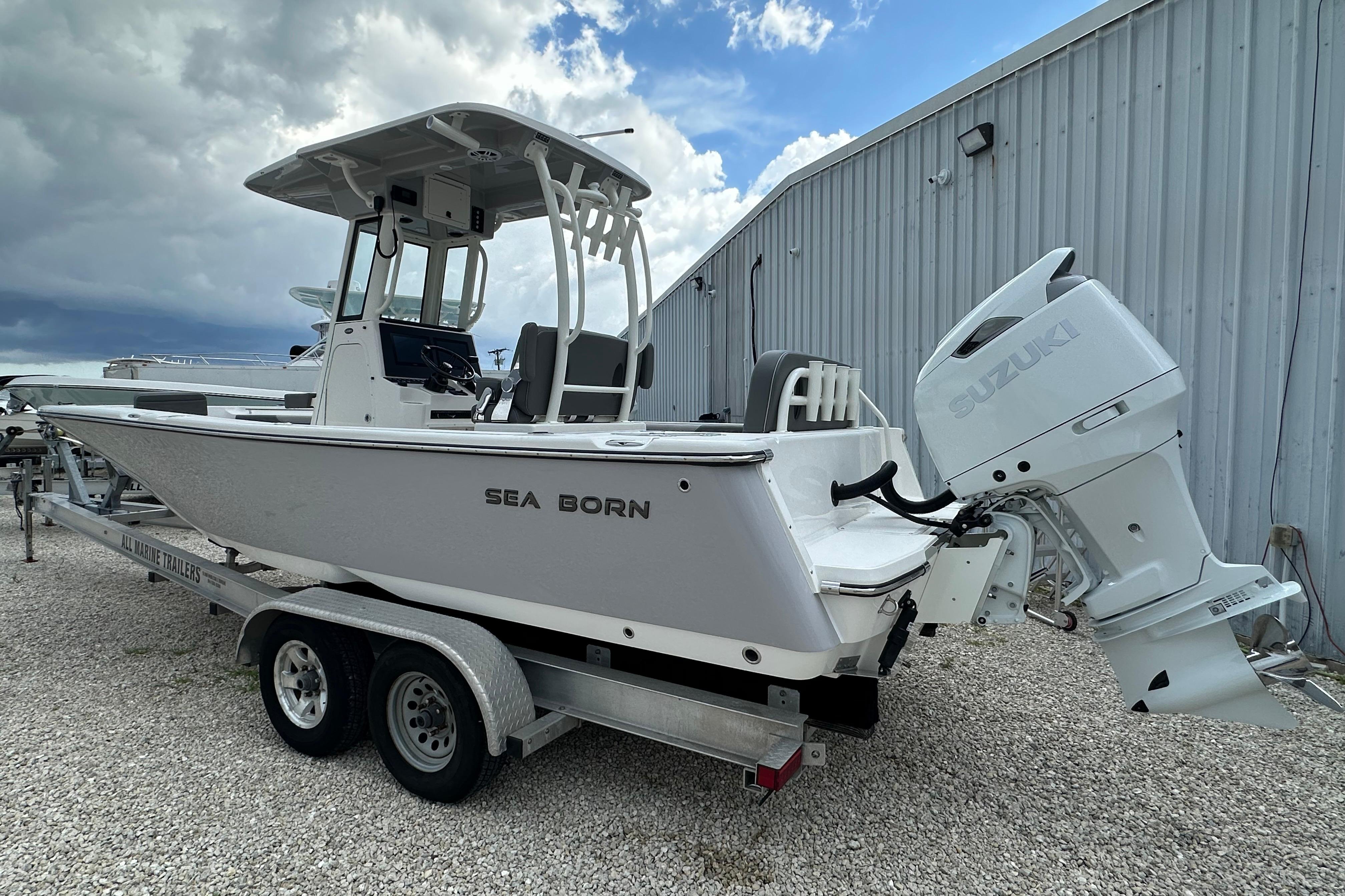 2027 Sea Born LX24 Center Console boat on trailer with Suzuki outboard motor.