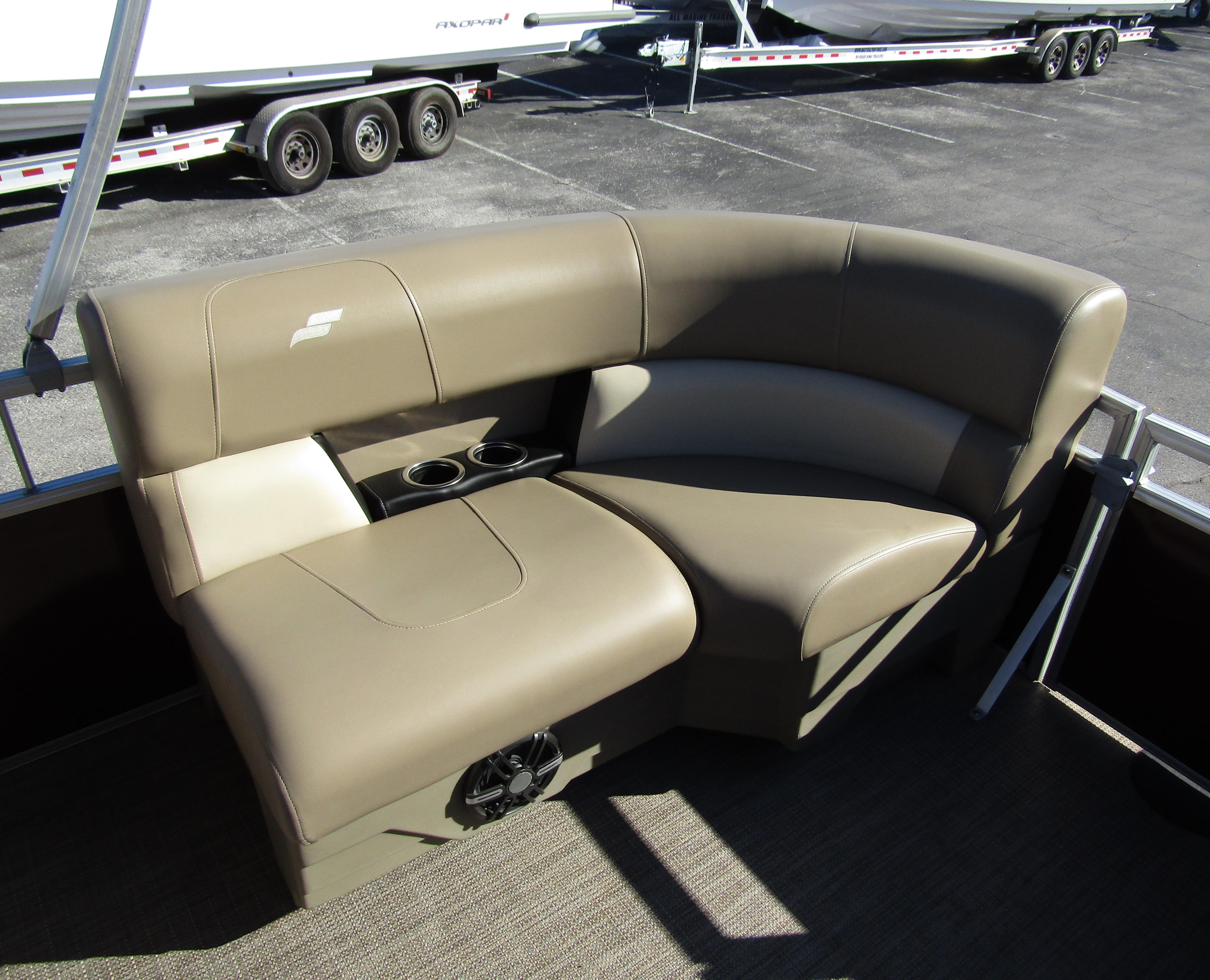 2024 Starcraft LX 20 R boat seating with cup holders, beige upholstery, and speaker.
