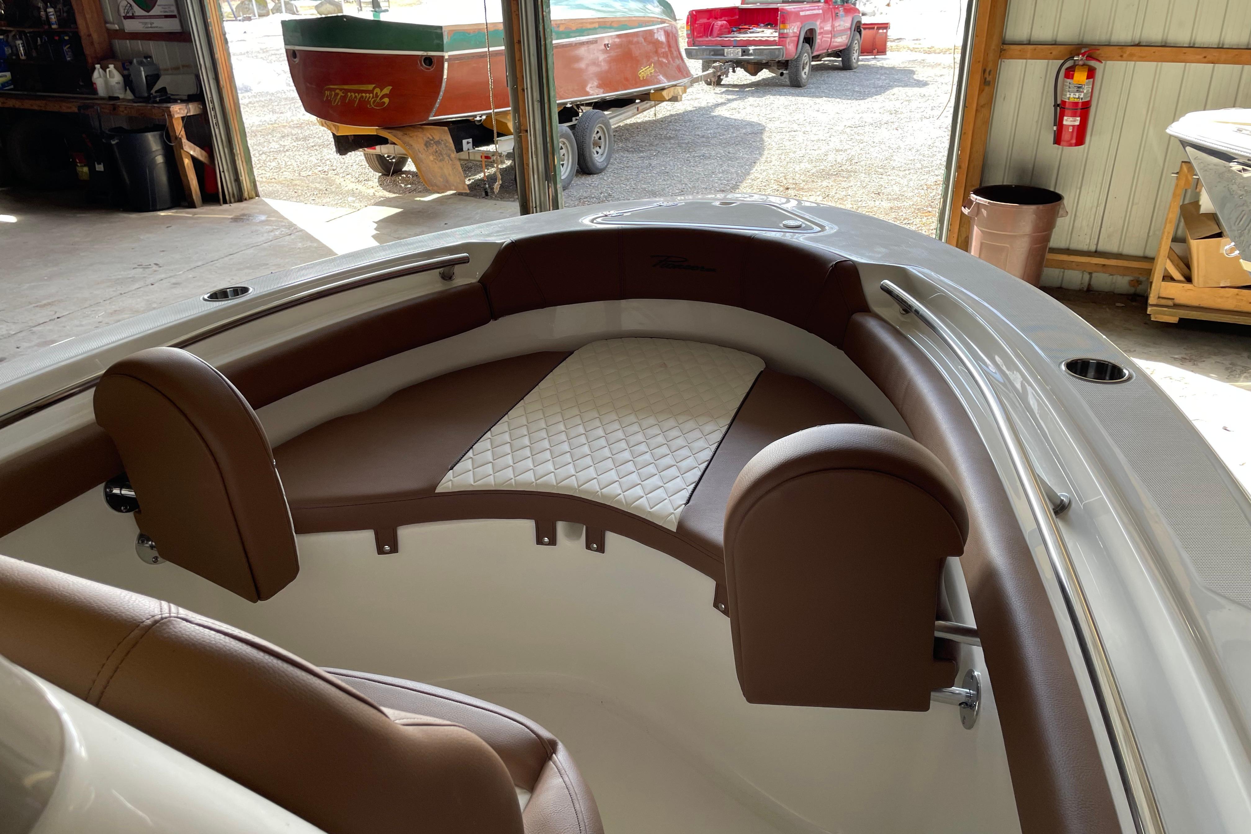 Interior of 2026 Pioneer 202 Islander boat with brown and white seating.