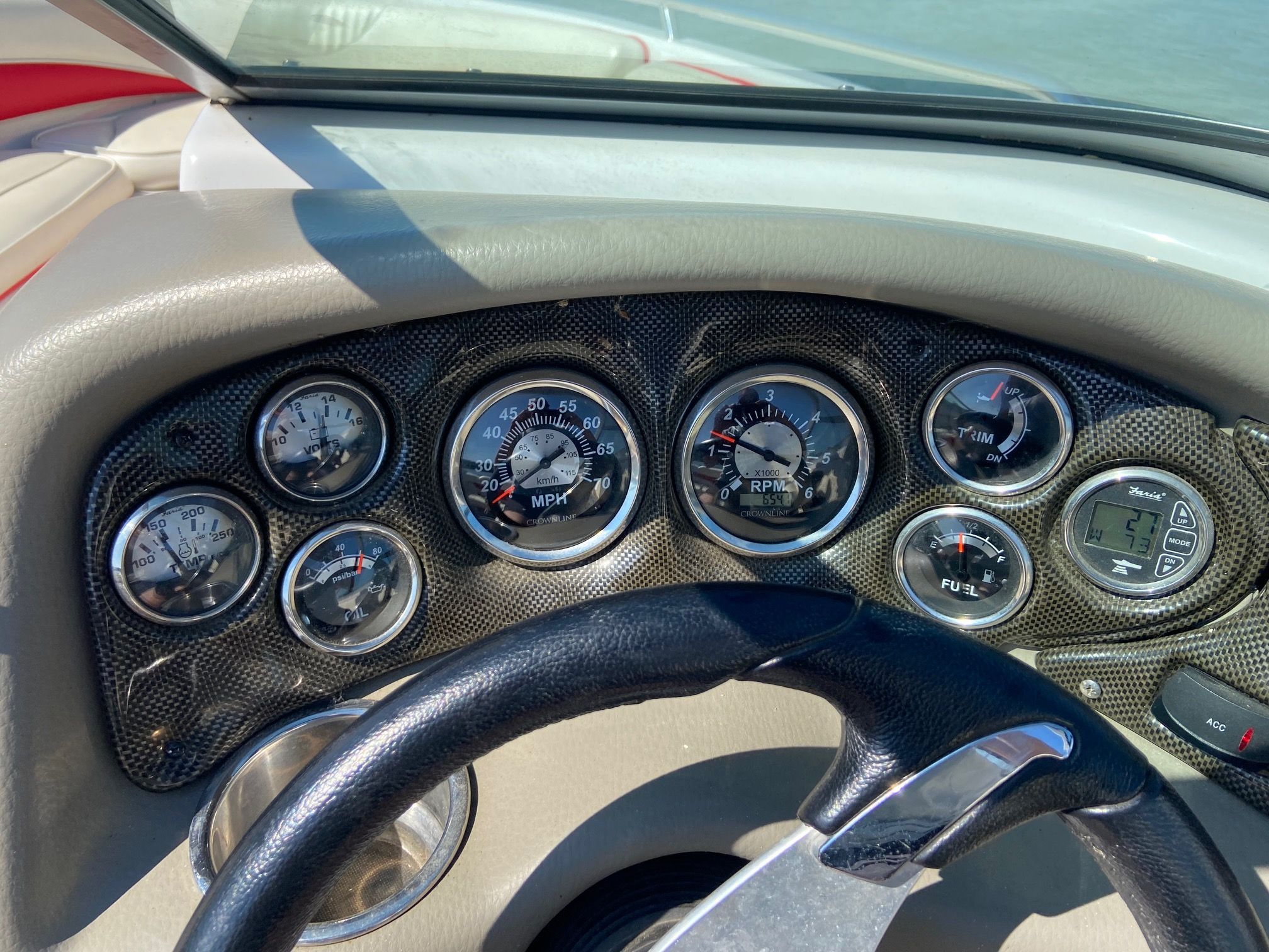 Dashboard of a Crownline 21 SS boat with speedometer, tachometer, and fuel gauge.