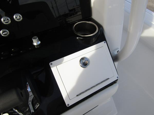 2025 Wellcraft 243 Fisherman console with cup holder and storage compartment.