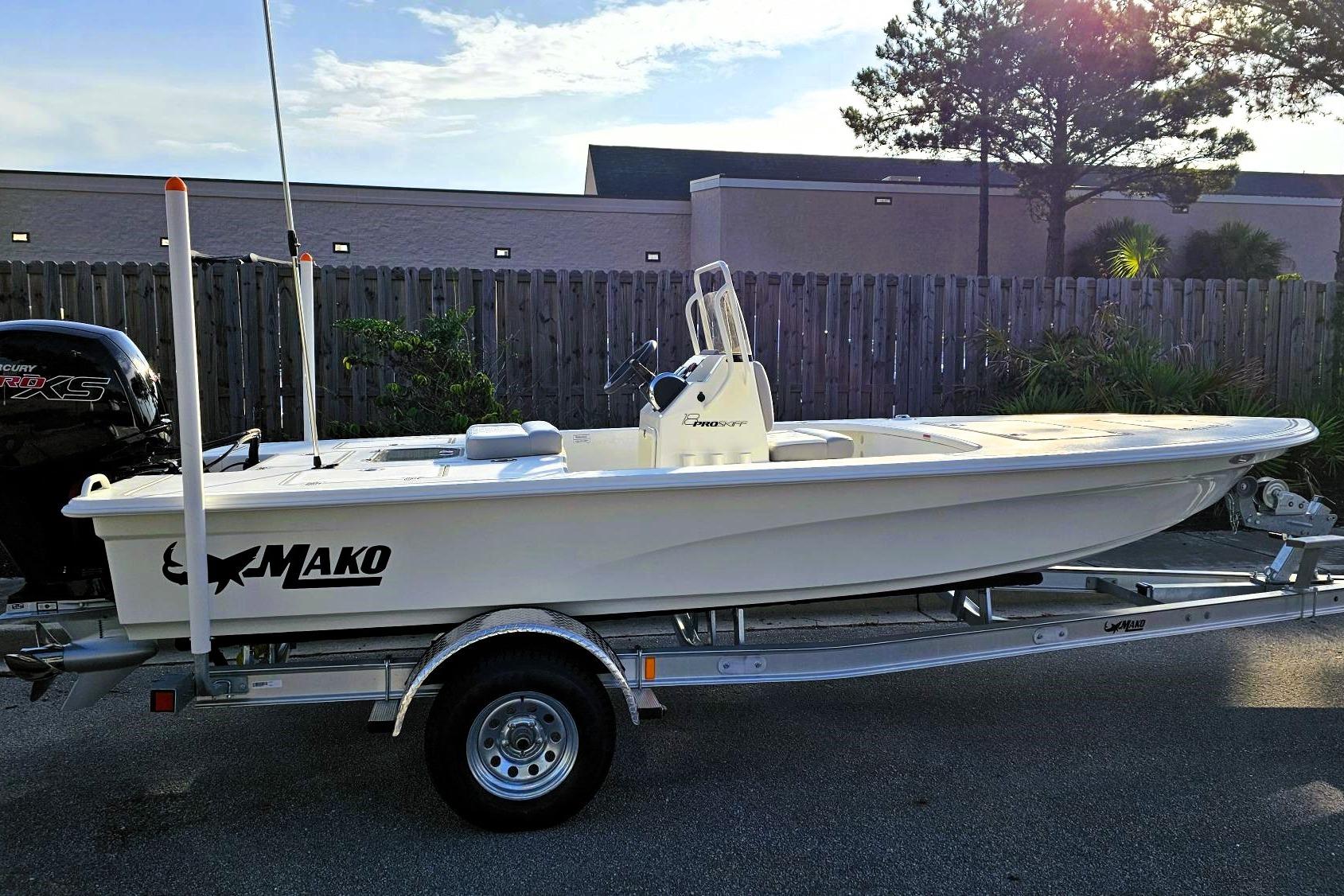 2026 Mako 18 Pro Skiff boat on trailer, parked outdoors, side view.