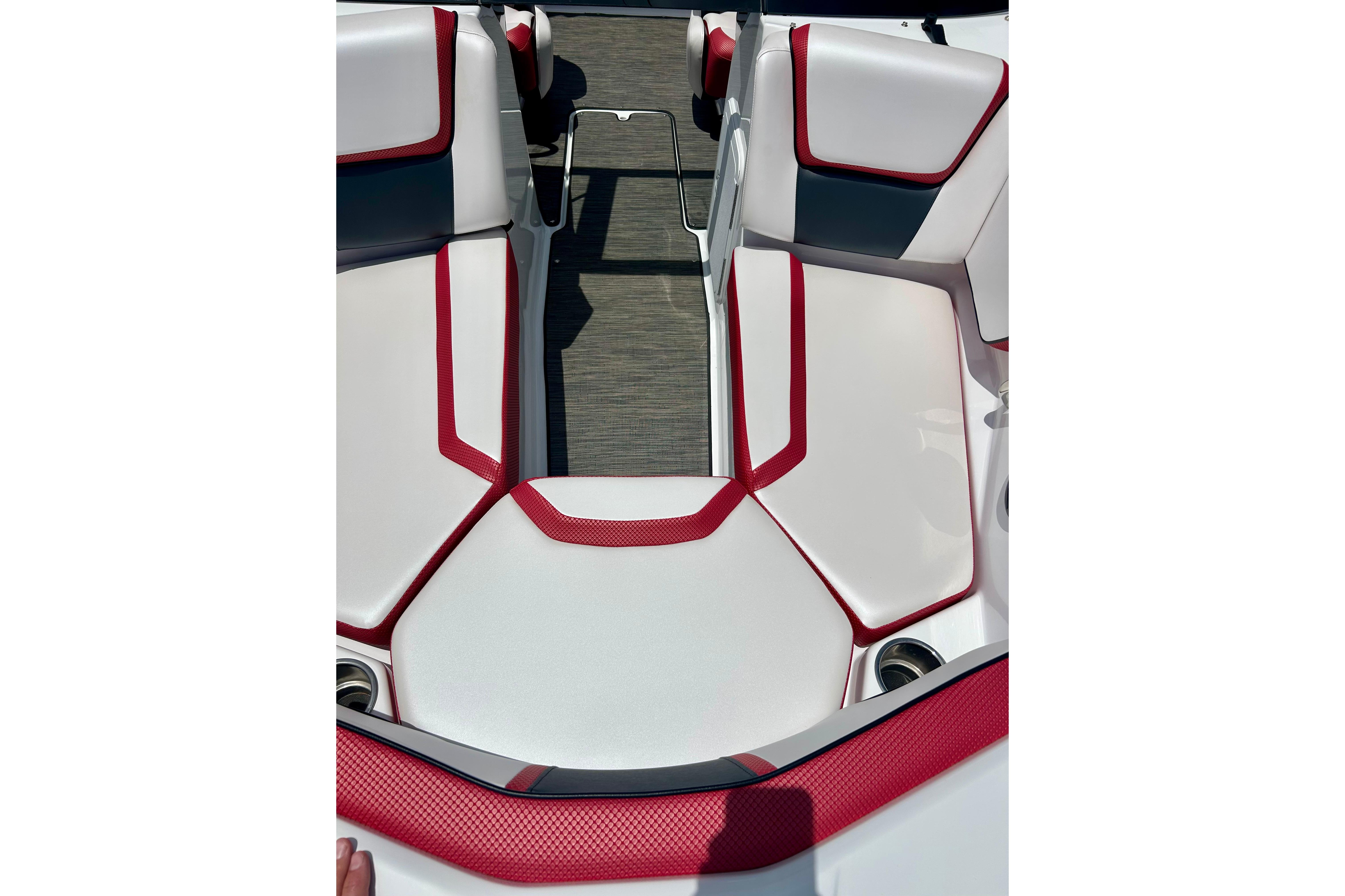 Interior seating of a 2021 Scarab 195 ID boat with red and white upholstery.