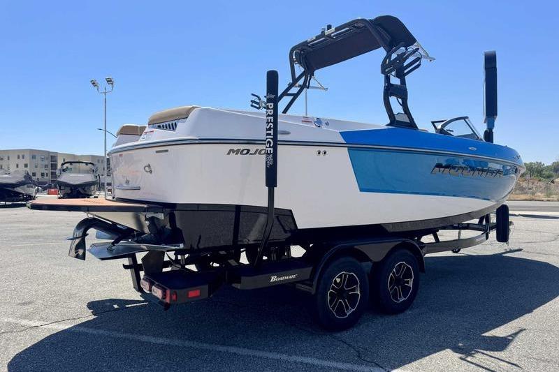2023 Moomba Mojo Pro boat on trailer in parking lot, side view.