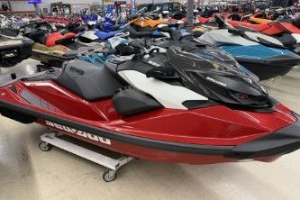 2024 Sea-Doo RXP-X 325 jet ski in showroom, vibrant red color.