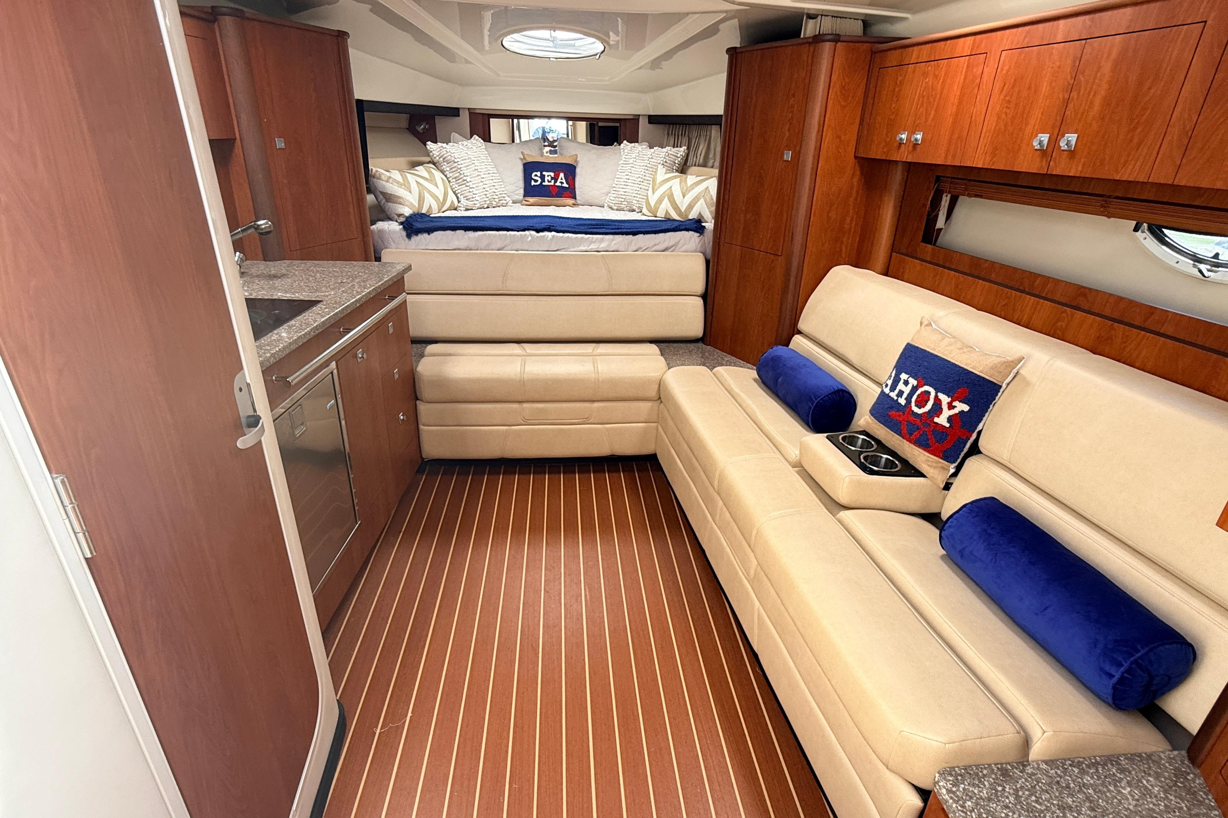 Luxurious interior of 2011 Monterey 320 Sport Yacht with plush seating and elegant wood finishes.