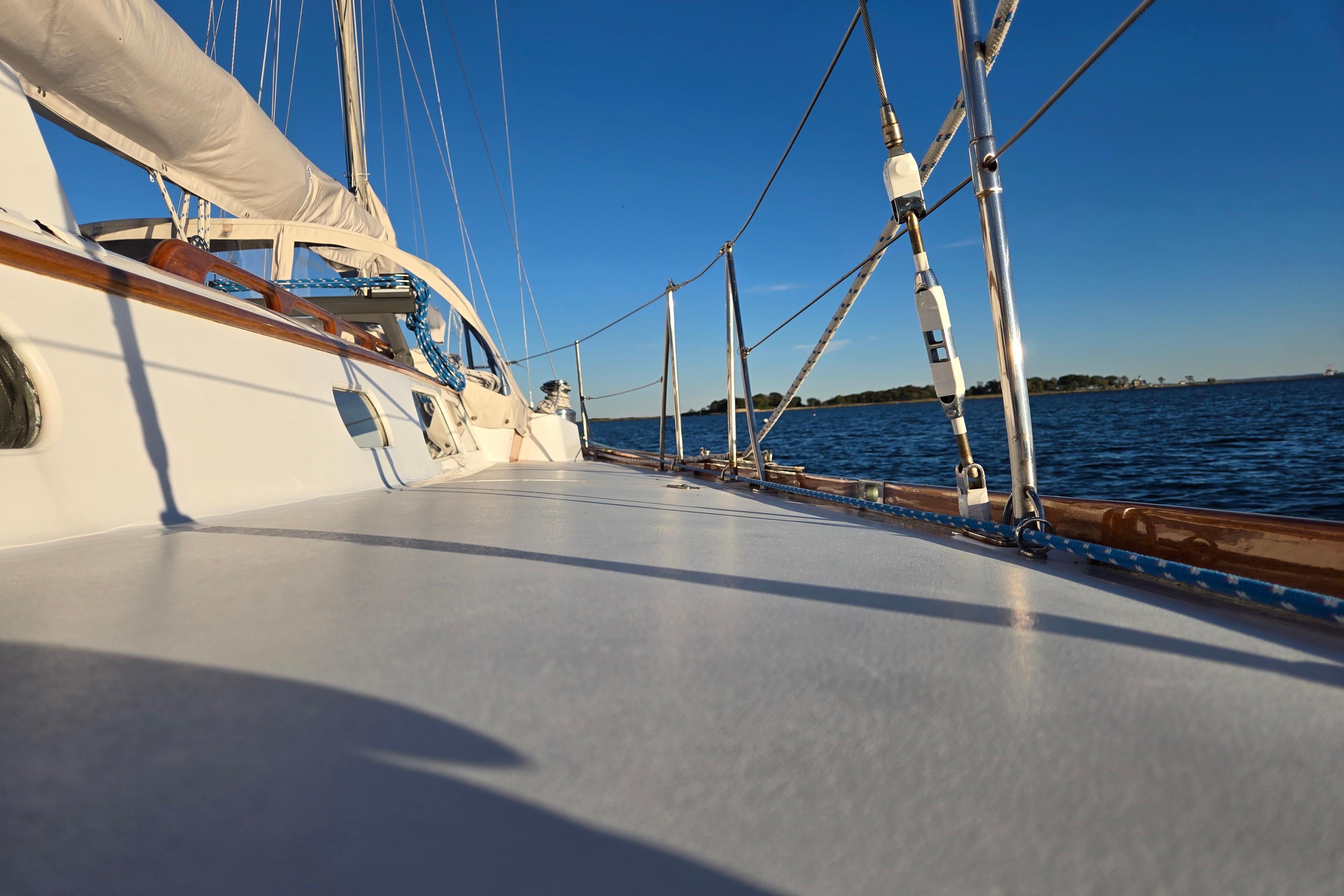 1970 Hinckley Bermuda 40 sailboat deck with ocean view under clear blue sky.