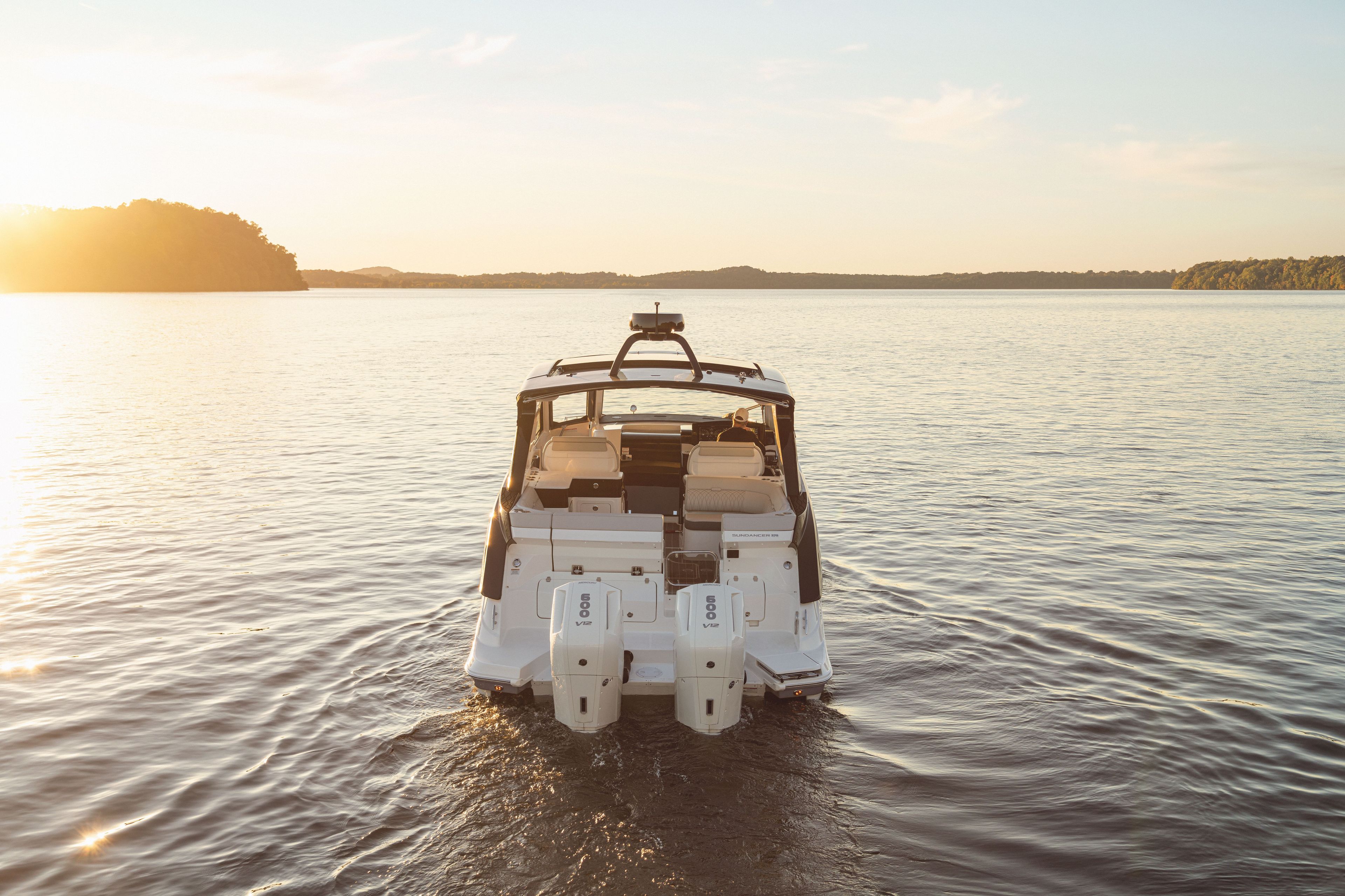 2026 Sea Ray Sundancer 370 Outboard on calm water at sunset.