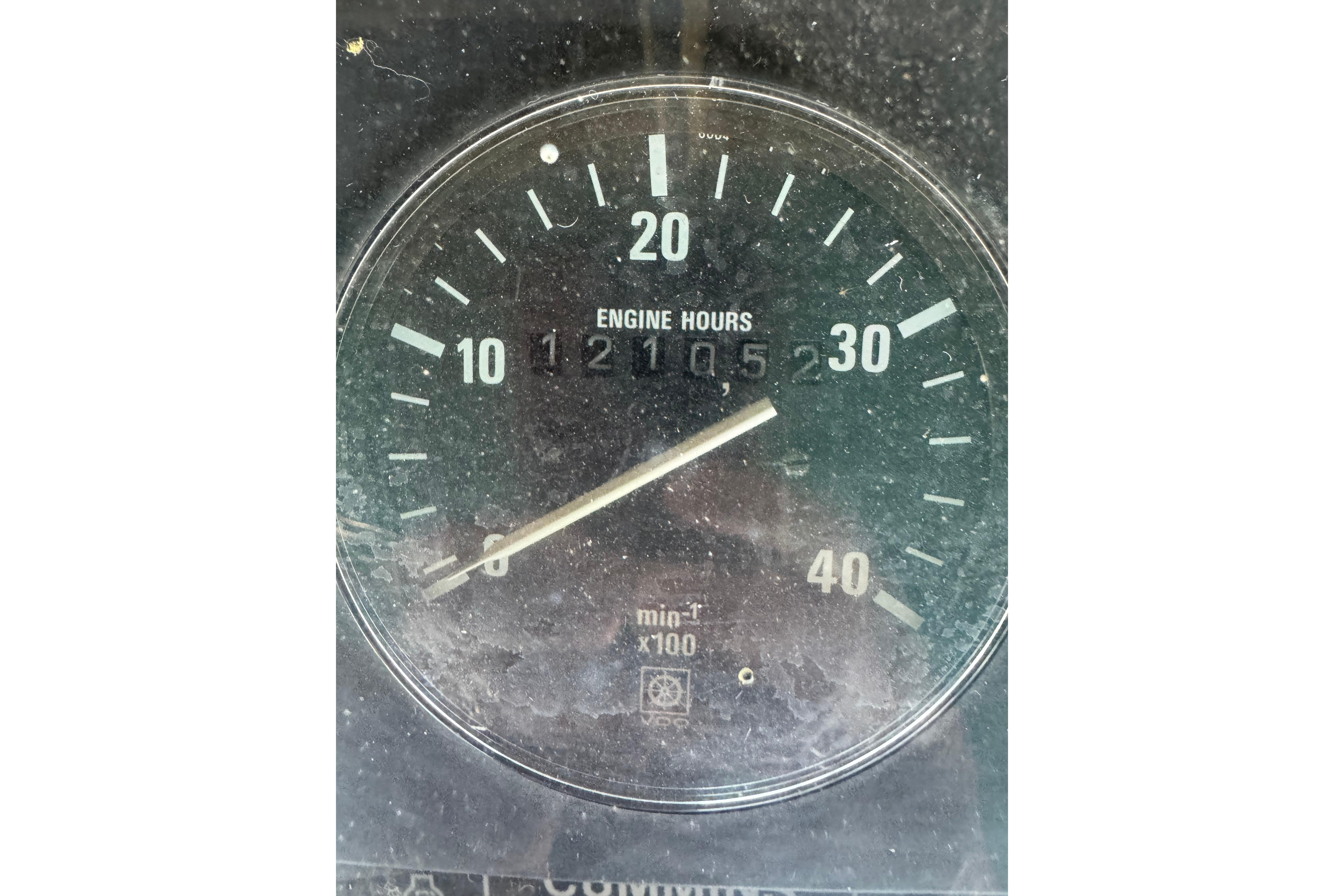 Close-up of a Nordic Tug 32 engine hour meter showing 1210.5 hours.