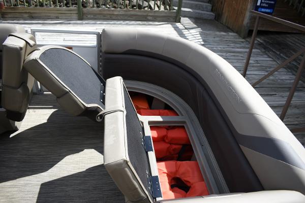 2023 Bennington 22 SXCW boat interior with storage compartments and life jackets.