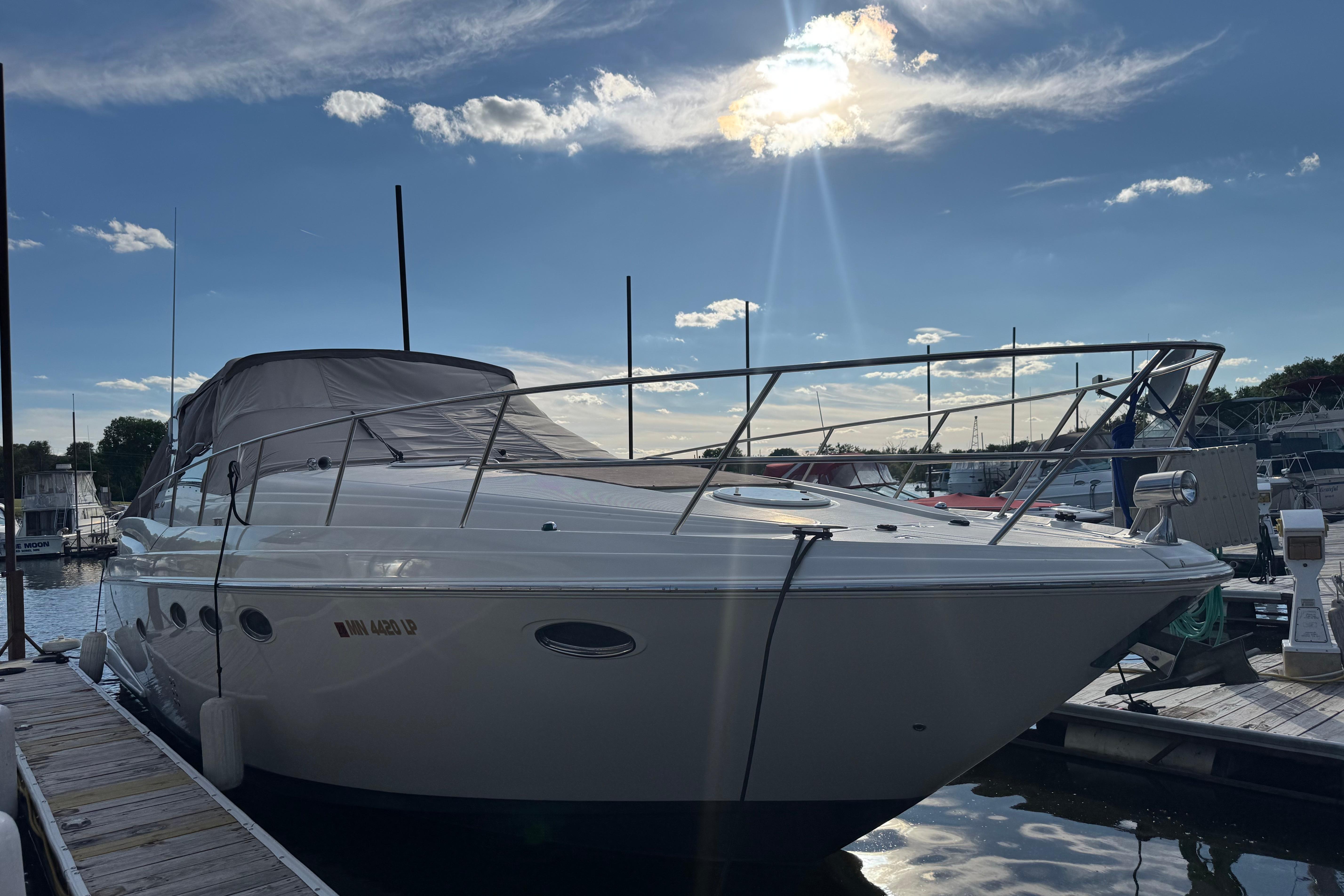 2007 Regal Commodore 3860 yacht docked under a sunny sky at a marina.