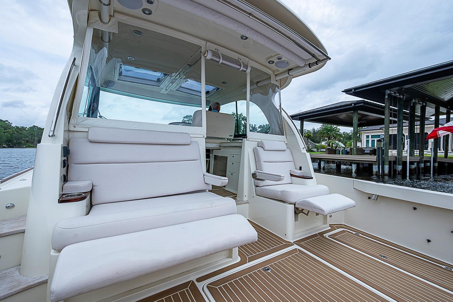 2023 Hinckley Sport Boat 40 X interior with white seating and wooden deck.