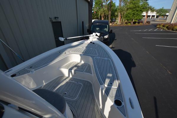 2021 Sea Pro 228 Bay boat with sleek deck design, parked near a building.