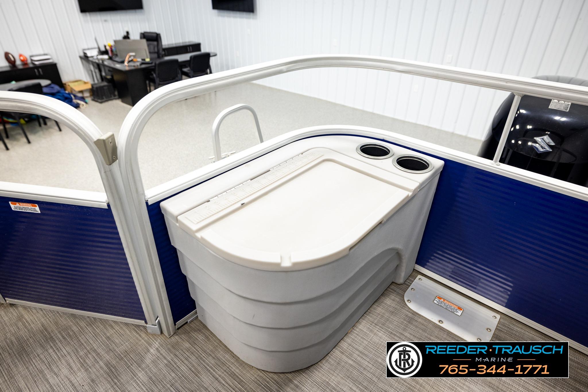 2021 Bennington 20 SV boat interior with cup holders, displayed in showroom.