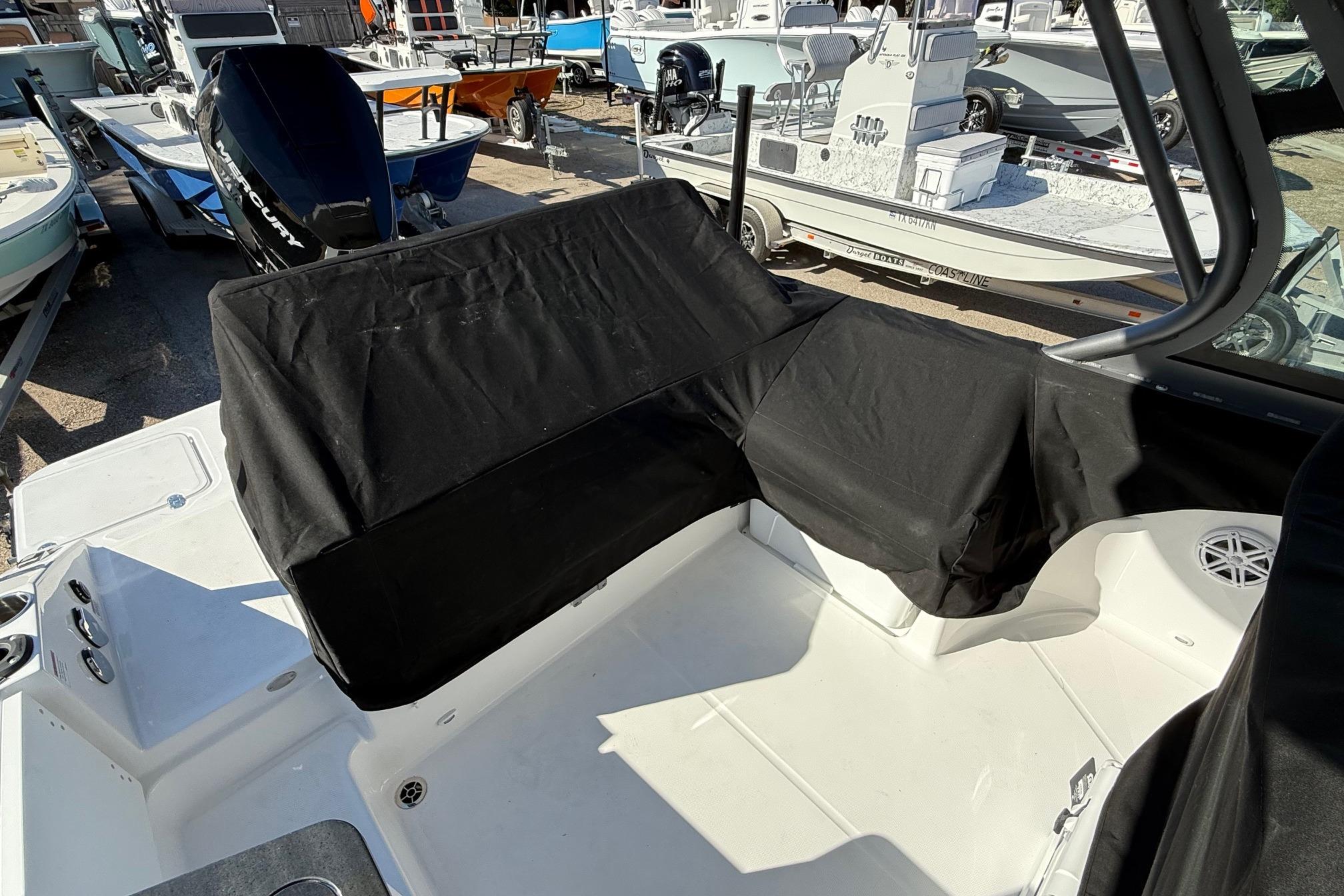 Interior of a 2026 Monterey Elite 27 OB boat with covers.