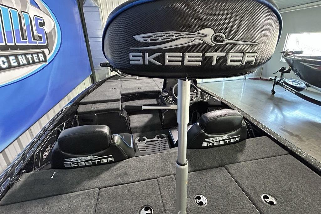 2026 Skeeter ZX200 boat interior with branded seats and steering wheel in showroom.