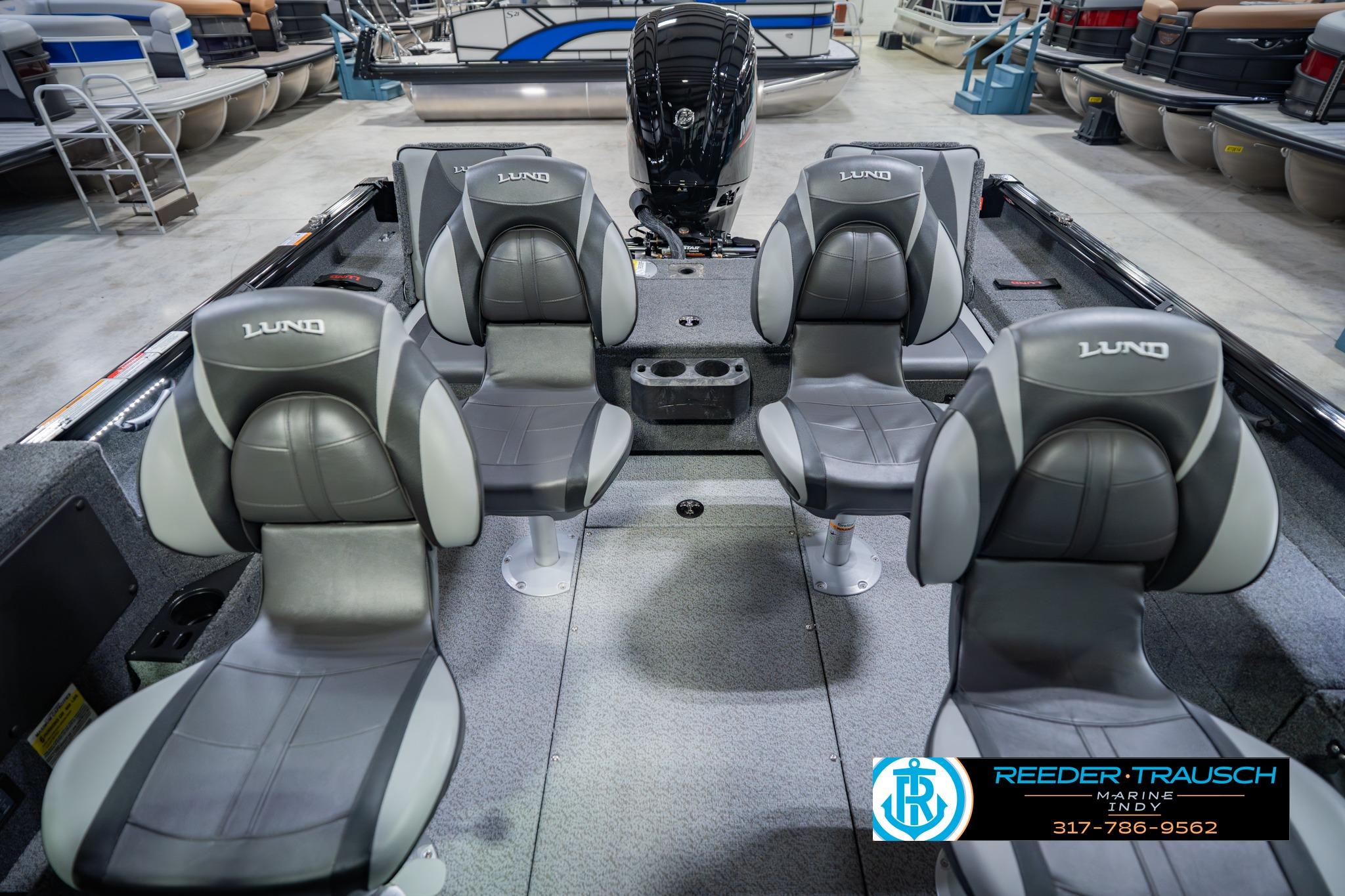 2026 Lund 1775 Impact XS boat interior with four gray seats in showroom.