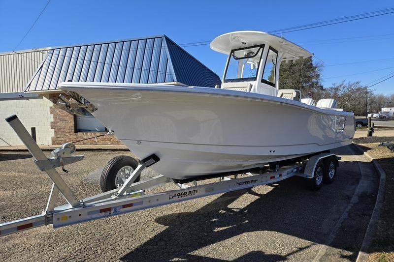 2026 Sea Hunt Ultra 275 Coffin Box boat on trailer, parked outdoors.